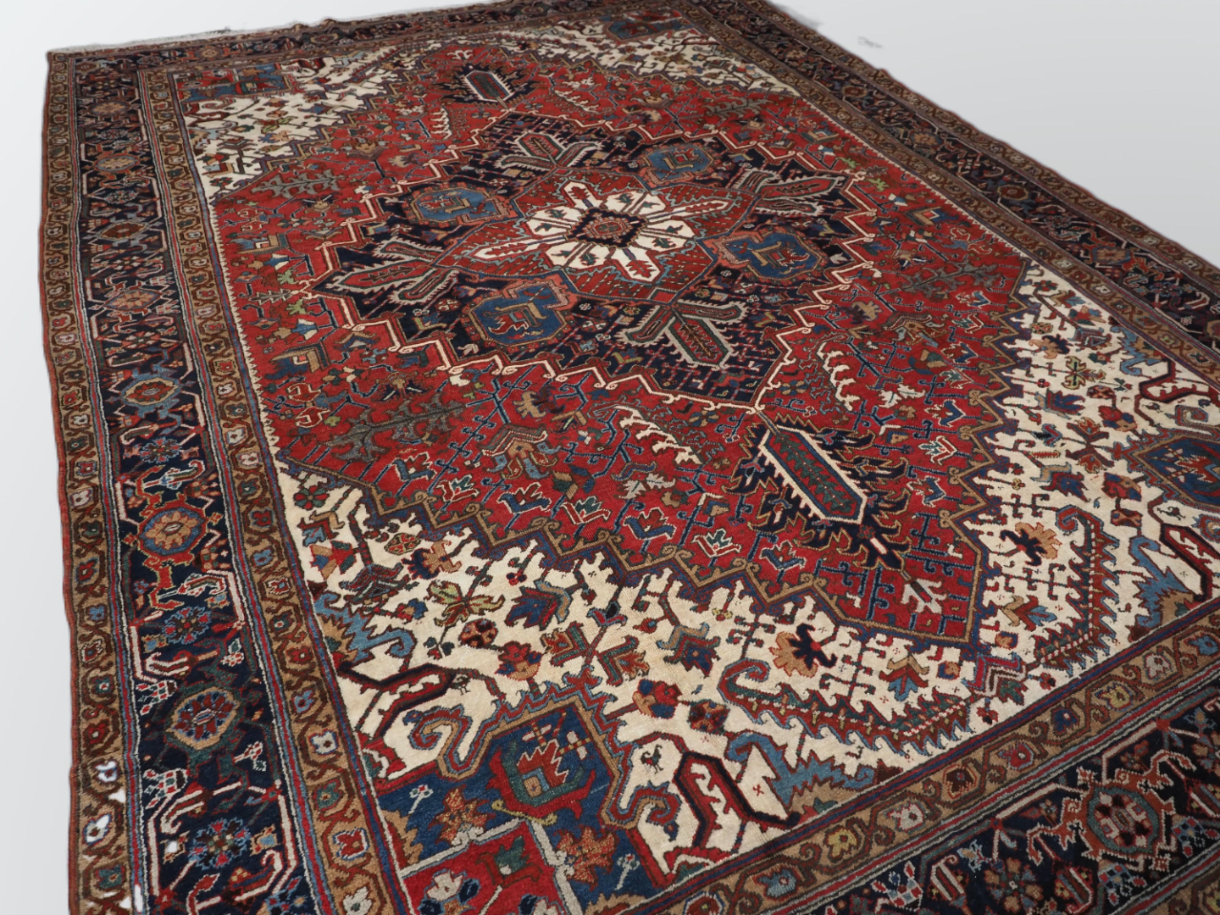 Size: 12ft 10in x 9ft 4in (390 x 285cm).

Antique Persian Heriz carpet with a traditional large medallion design with madder red field colour. Classic dark indigo blue border that is very well drawn. The large central medallion in dark indigo blue