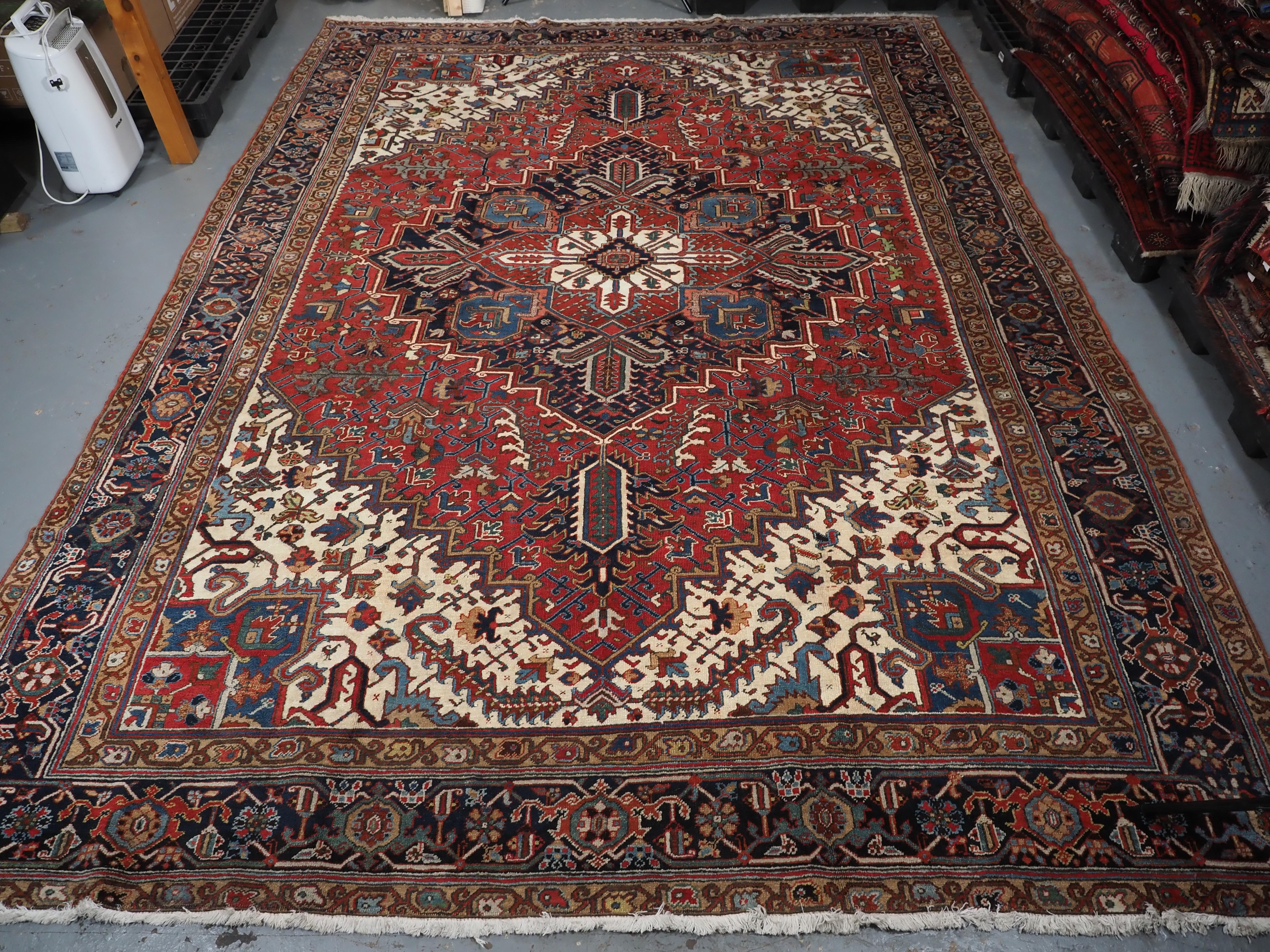Persian Antique Heriz carpet with traditional large medallion design, circa 1920 For Sale