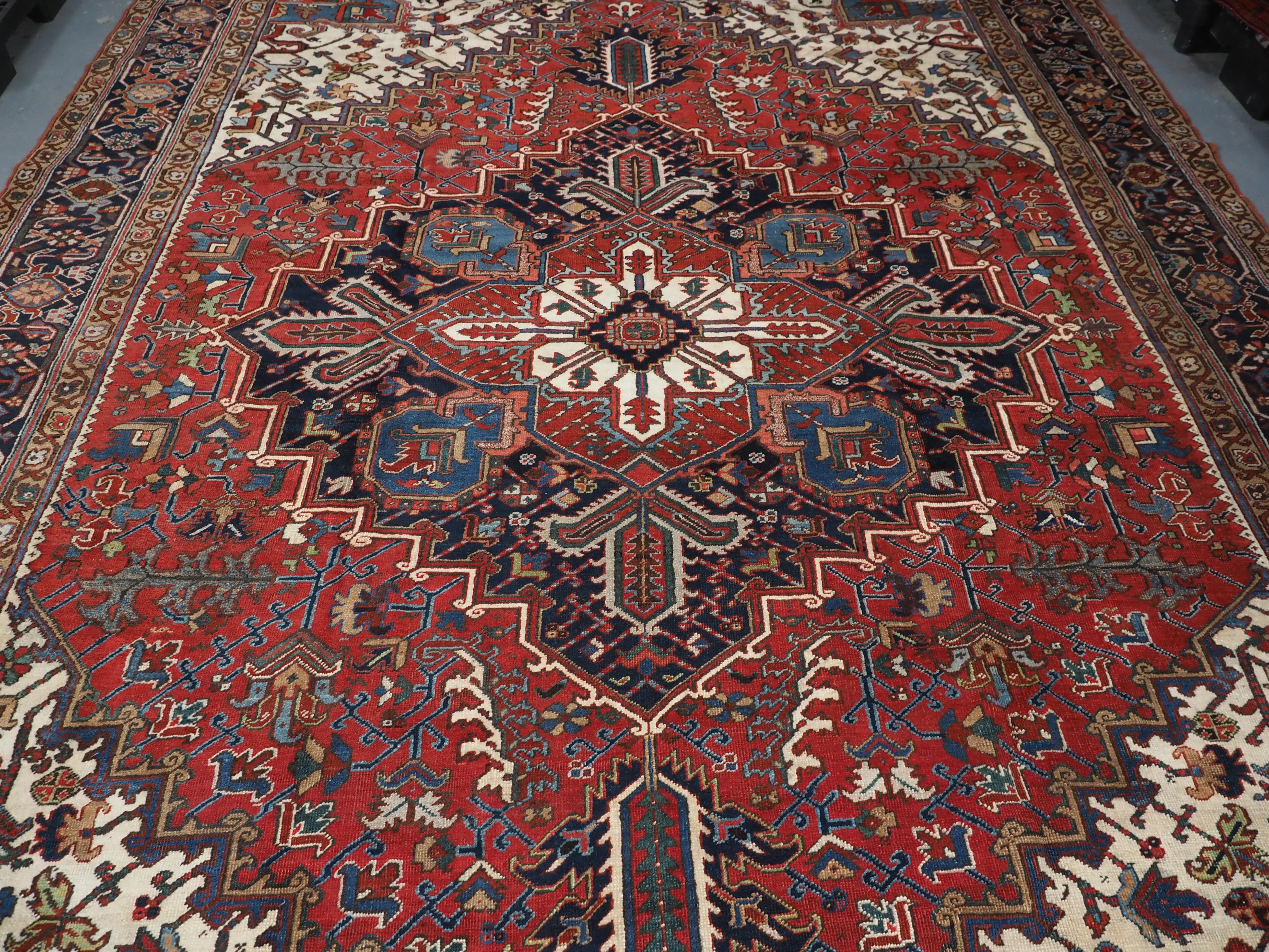 Wool Antique Heriz carpet with traditional large medallion design, circa 1920 For Sale