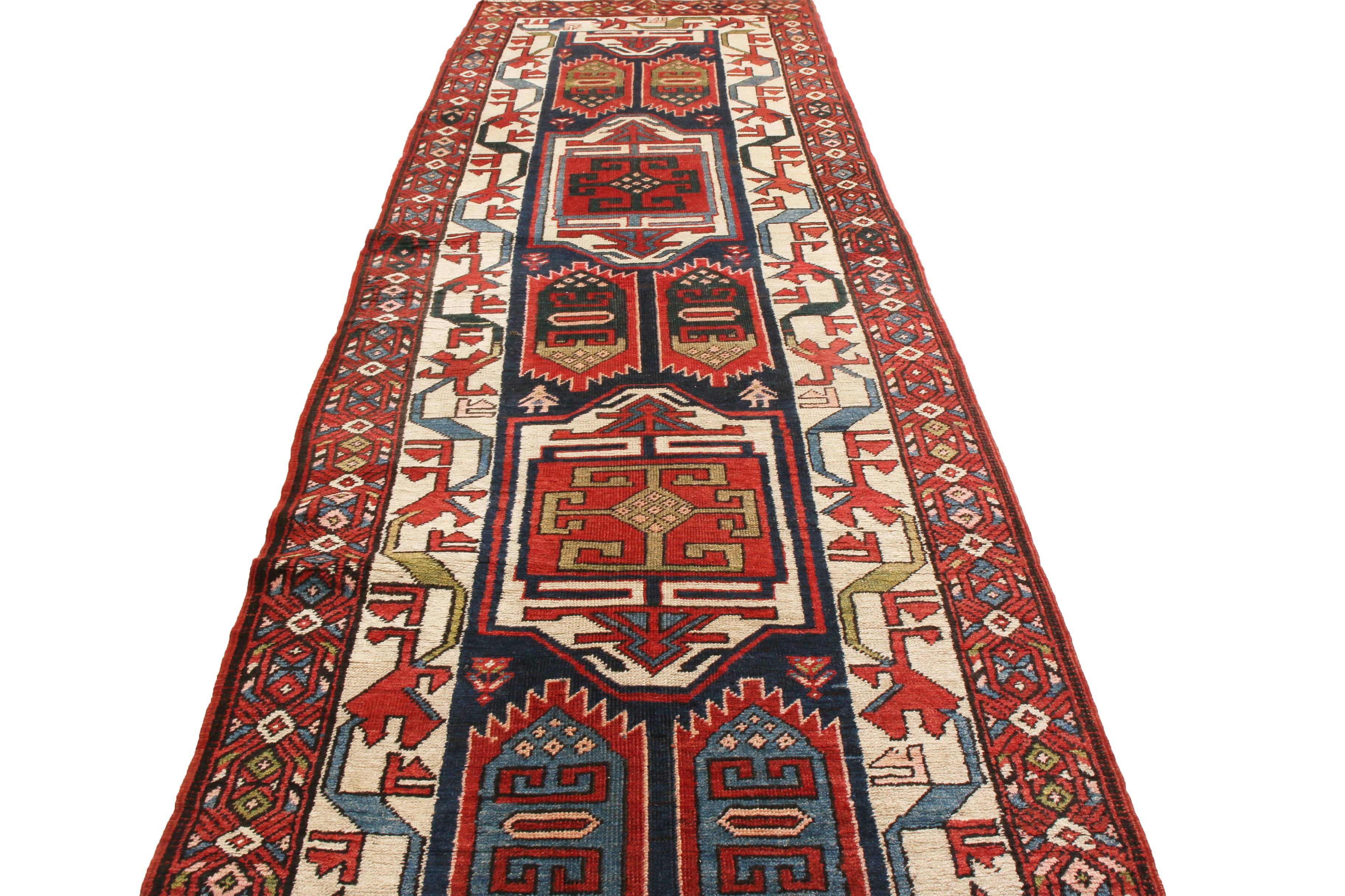 Originating from Persia in 1880, this antique Persian runner is hand-knotted in high-quality wool, featuring a Heriz design. Named for one of the most time-honored centers of Persian rug production in history, the field design repeats several tribal
