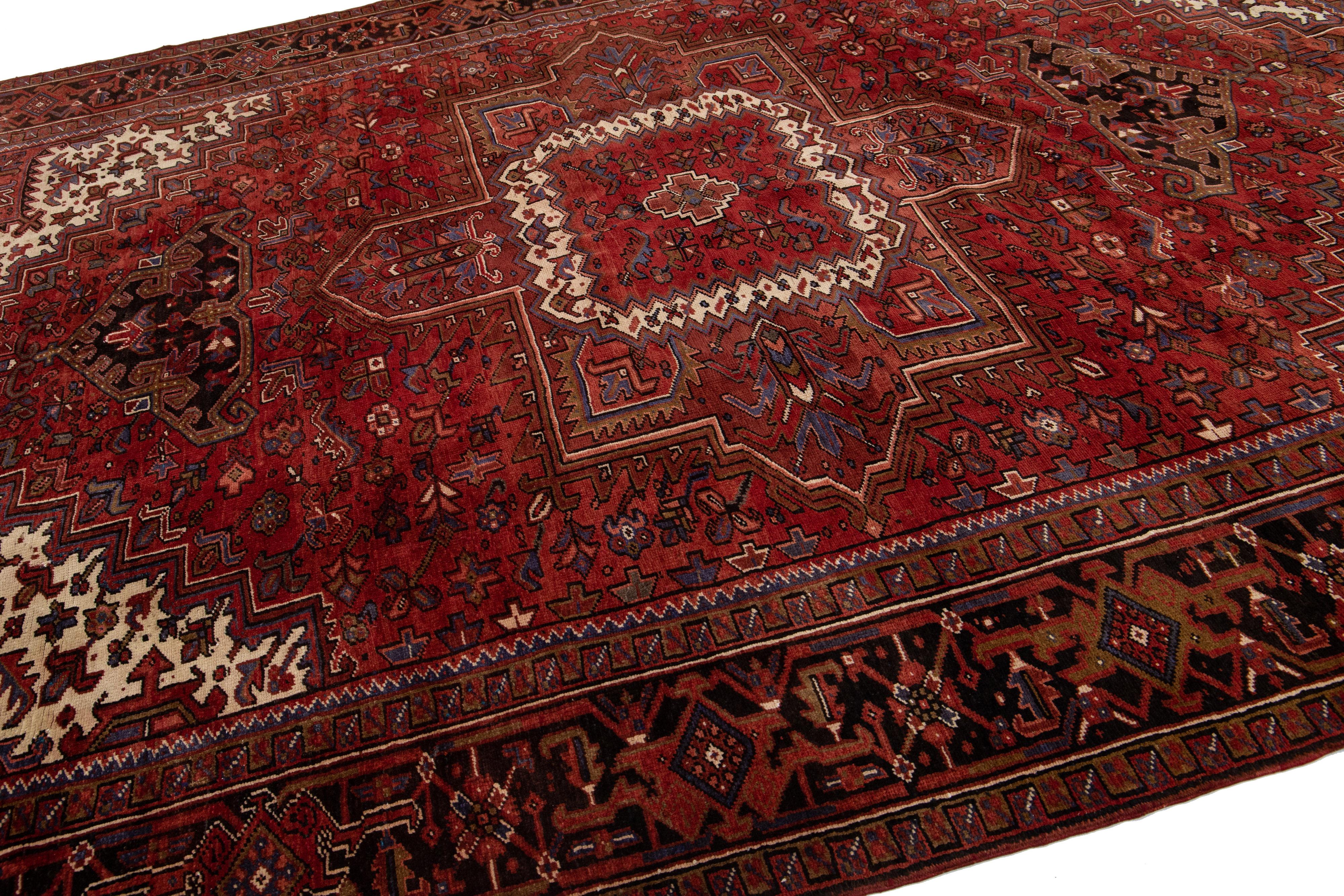 20th Century Antique Heriz Red Handmade Persian Wool Rug with Medallion Motif For Sale