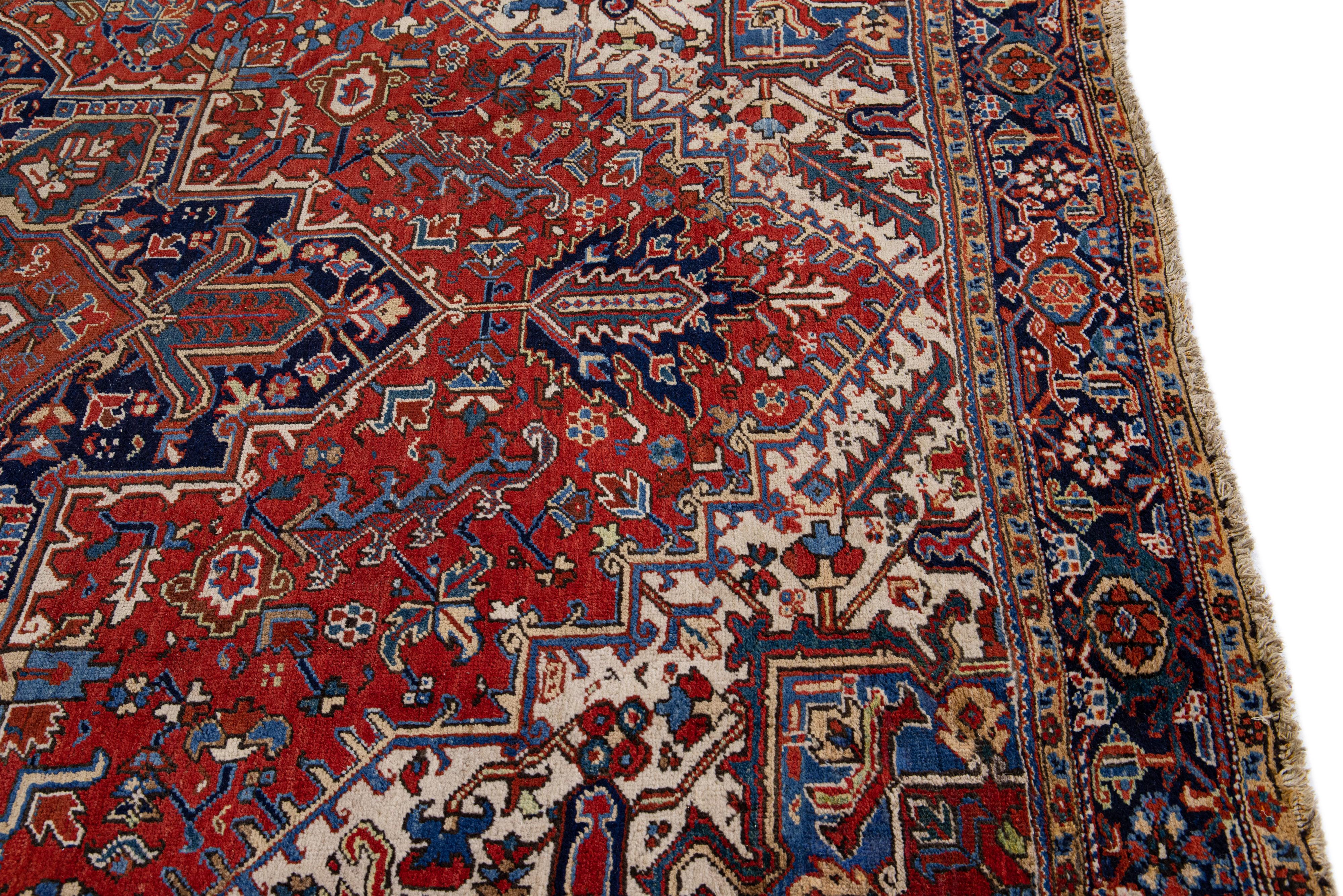 20th Century Antique Heriz Red Handmade Persian Wool Rug with Multicolor Medallion Design For Sale