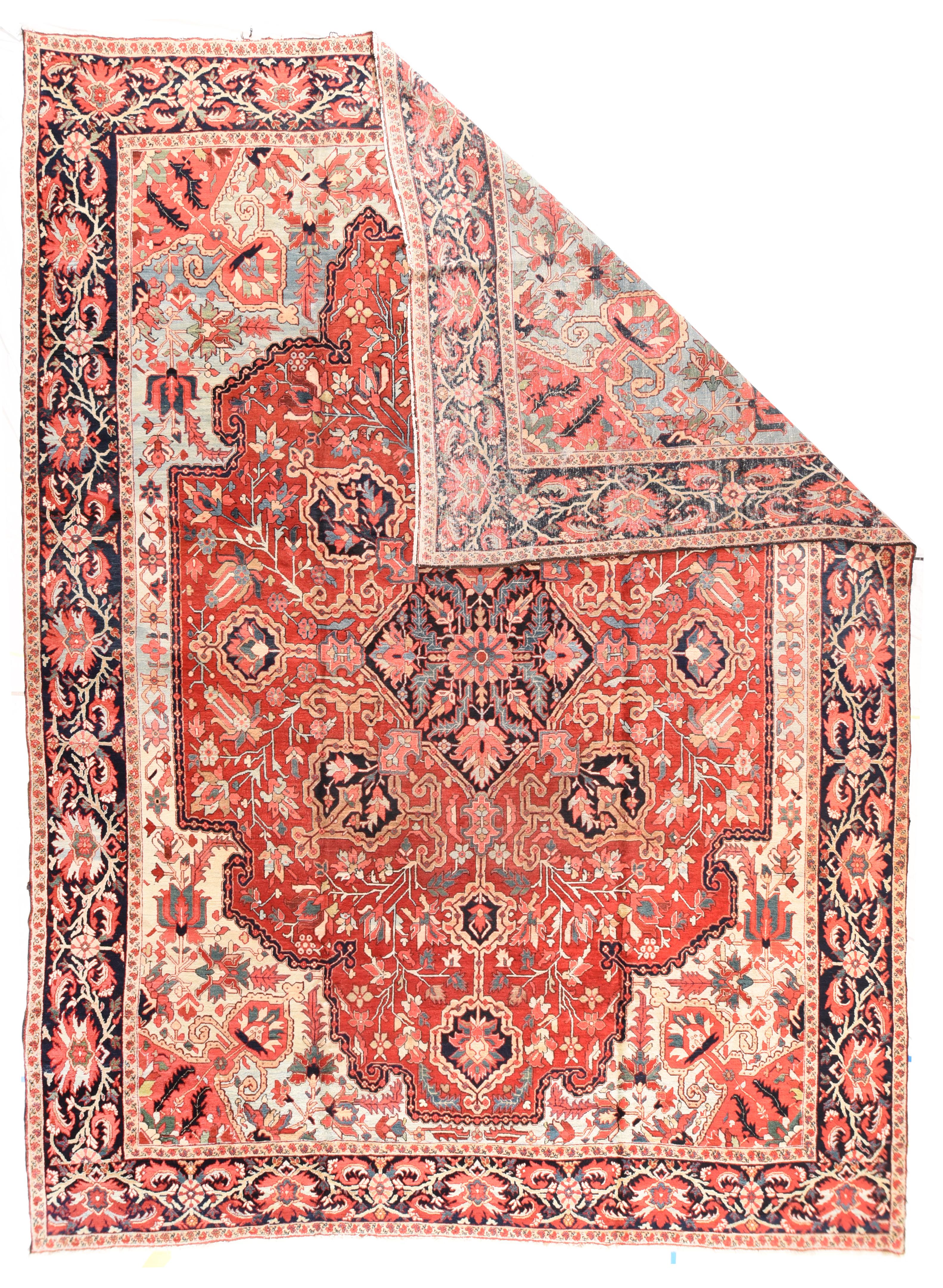 Antique Heriz Rug 11'8'' x 15'8''. The encompassing field abrashes from sky blue to powder to virtually sand, with diagonally in-projecting rust spadiform corners. The cartouche-shaped red subfield is centred by a navy, diamond shaped palmette