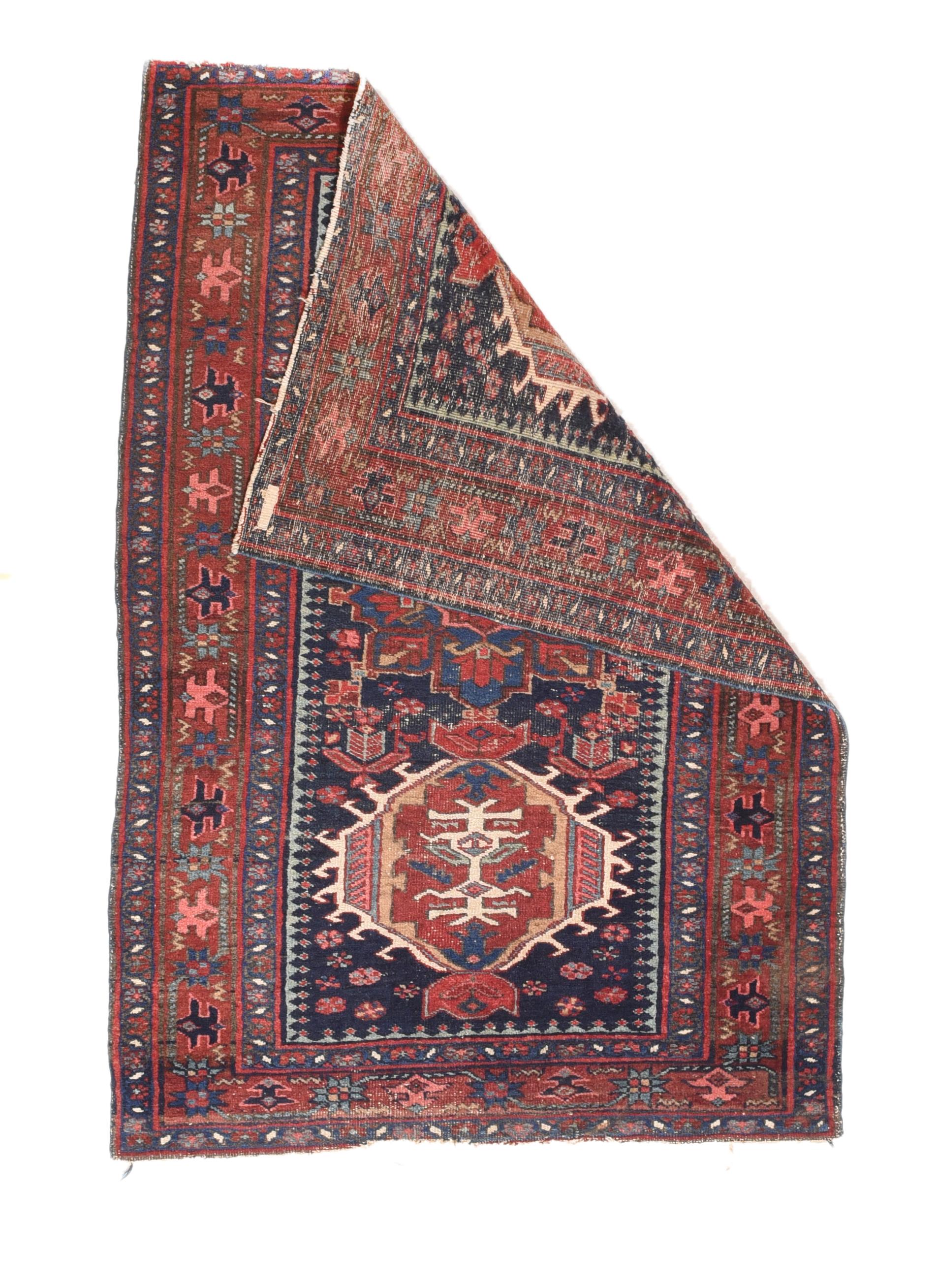 NW Persian village scatter of moderate weave with a navy field and three characteristic medallions in a pole layout, either ivory hooked hexagons or red octogramme. Red border of simplified reversing palmettes and associated stars. Light blue