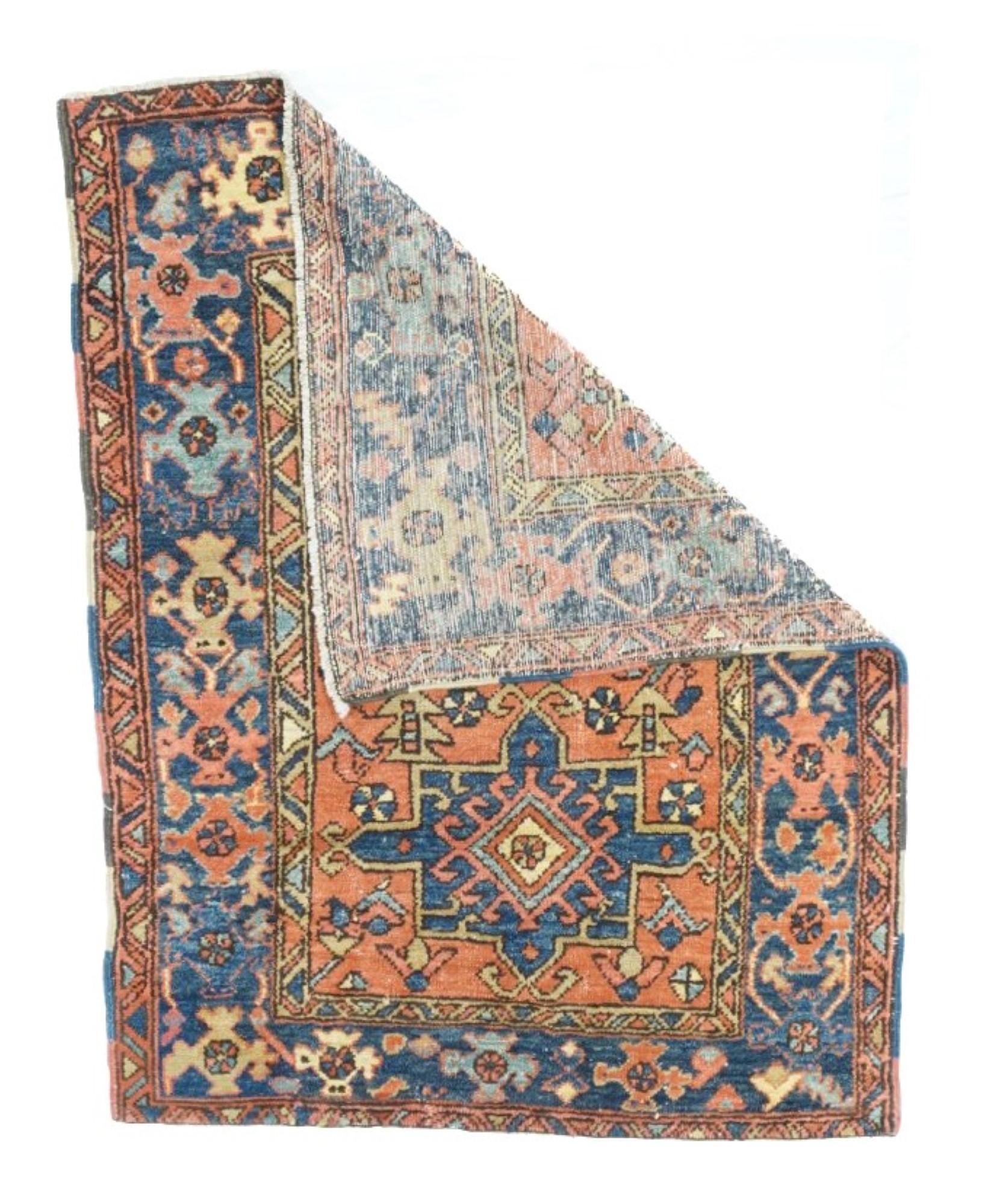 Antique Heriz Rug 3'3'' x 4'2''. Soft rust/terra cotta field with two royal blue Karaja-style octogrammes, and small flowers and geometric devices loosely scattered. Abrashed sapphire strip-style border with rough cross and turtle mixes. Cotton