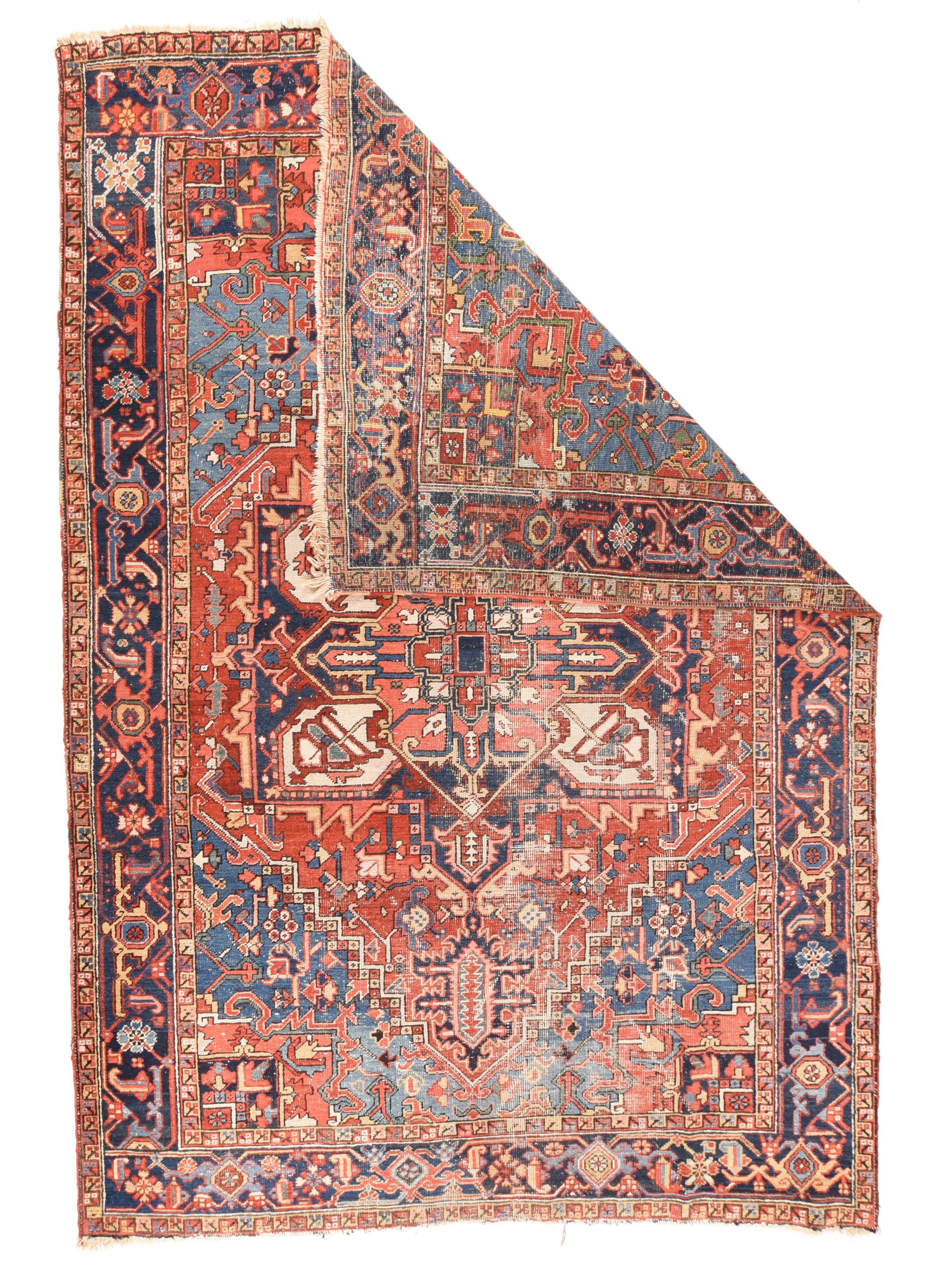 Antique Heriz Rug 6'8'' x 9'10''. Although spot-distressed, this NW Persian rural carpet still possesses noble points including the conjoint corners in transparent ice blue, and the strong navy and ecru radiating palmette octogramme medallion.