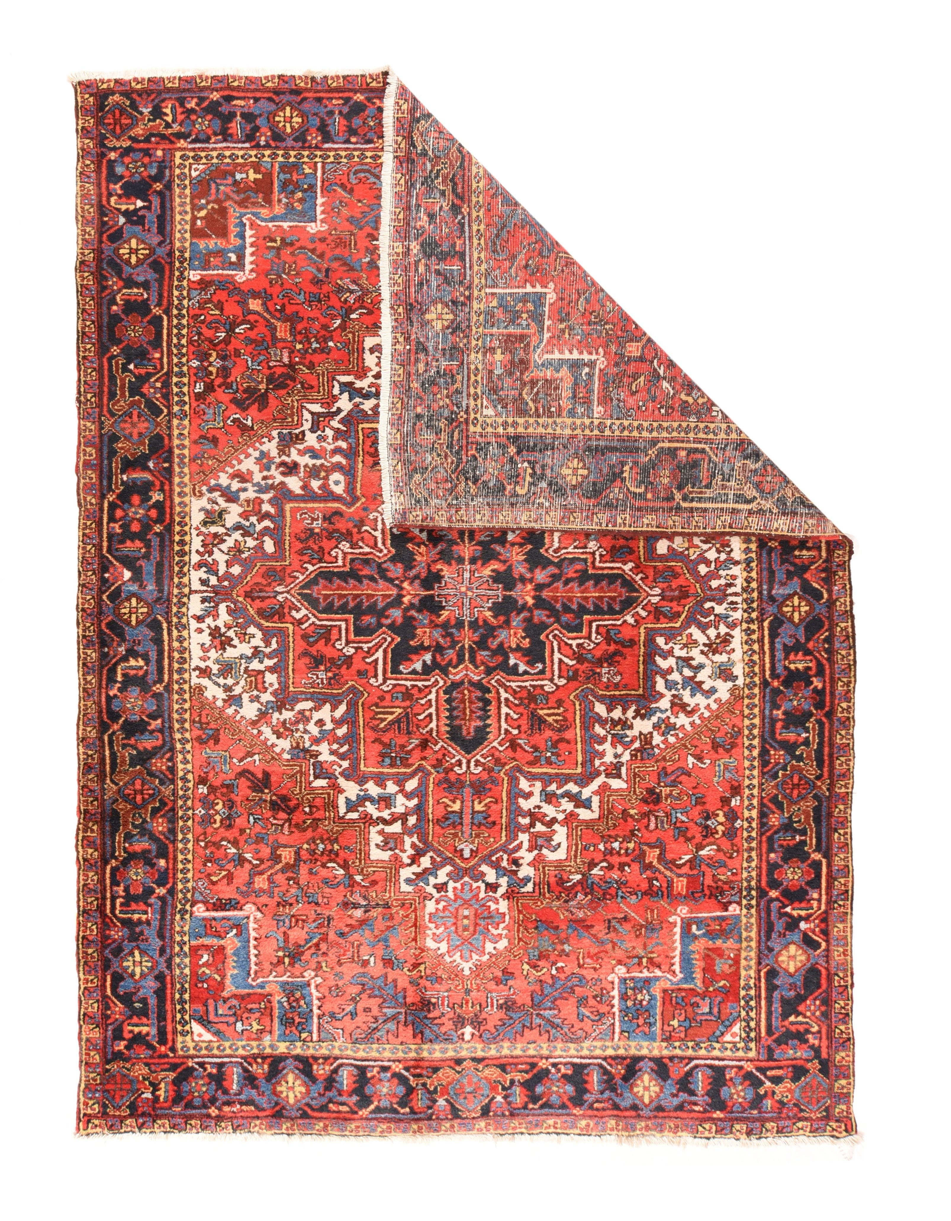 Antique Heriz Rug 7'9'' x 10'11''. A tonal inversion, with large, rust red, stepped corners, and a somewhat restricted ecru field anchored by a large rust red and navy nested leaf medallion. Stepped light blue corner cores. Straw inner border and