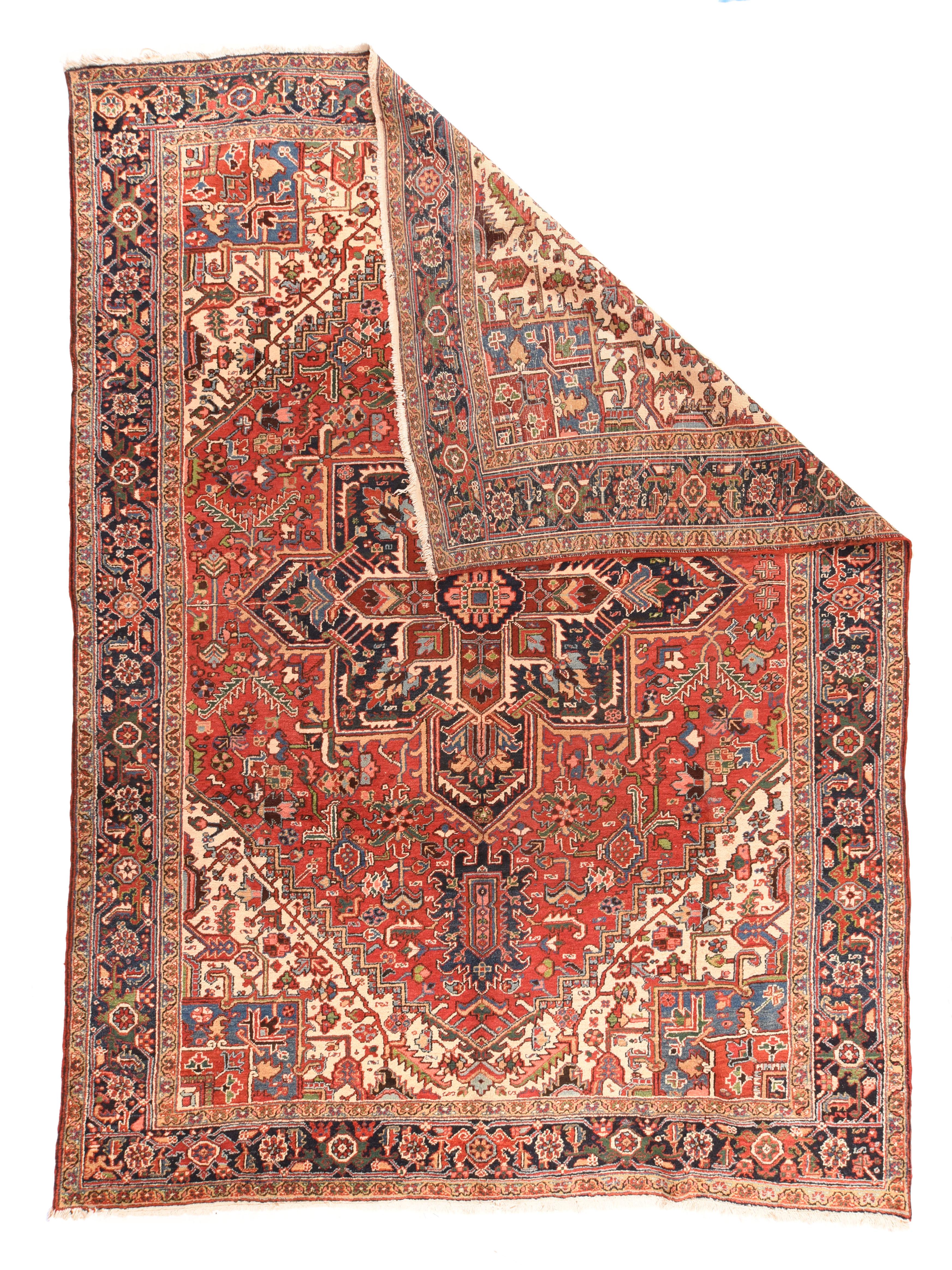 Antique Heriz rug measures: 9'3'' x 12'3''. This characteristic and beautiful NW Persian rustic carpet features an all-natural dye palette with a madder red field anchored by a layered navy and blood red pointed octogramme palmette medallion. The