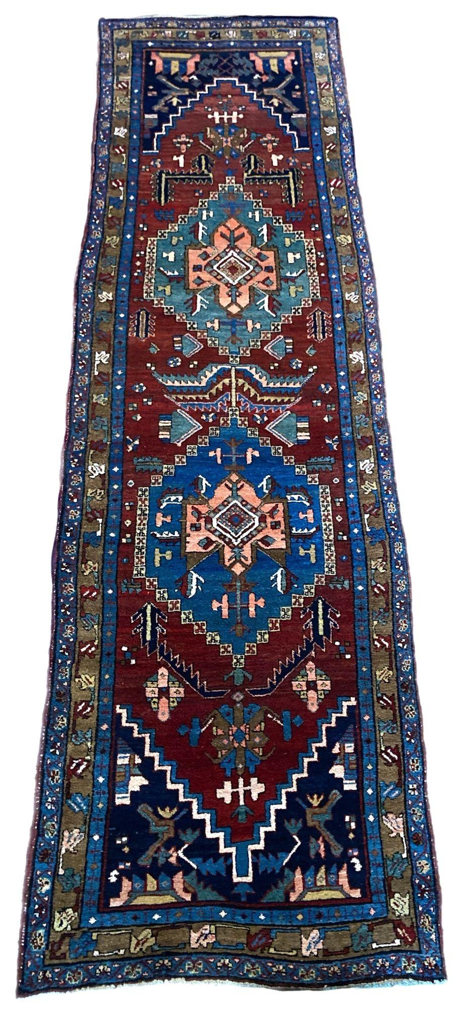 An outstanding antique Heriz runner in near original condition, hand woven circa 1910. The design features two lozenge medallions on a terracotta field surrounded by a camel coloured border. Fabulous full, chunky pile and lovely secondary colours,
