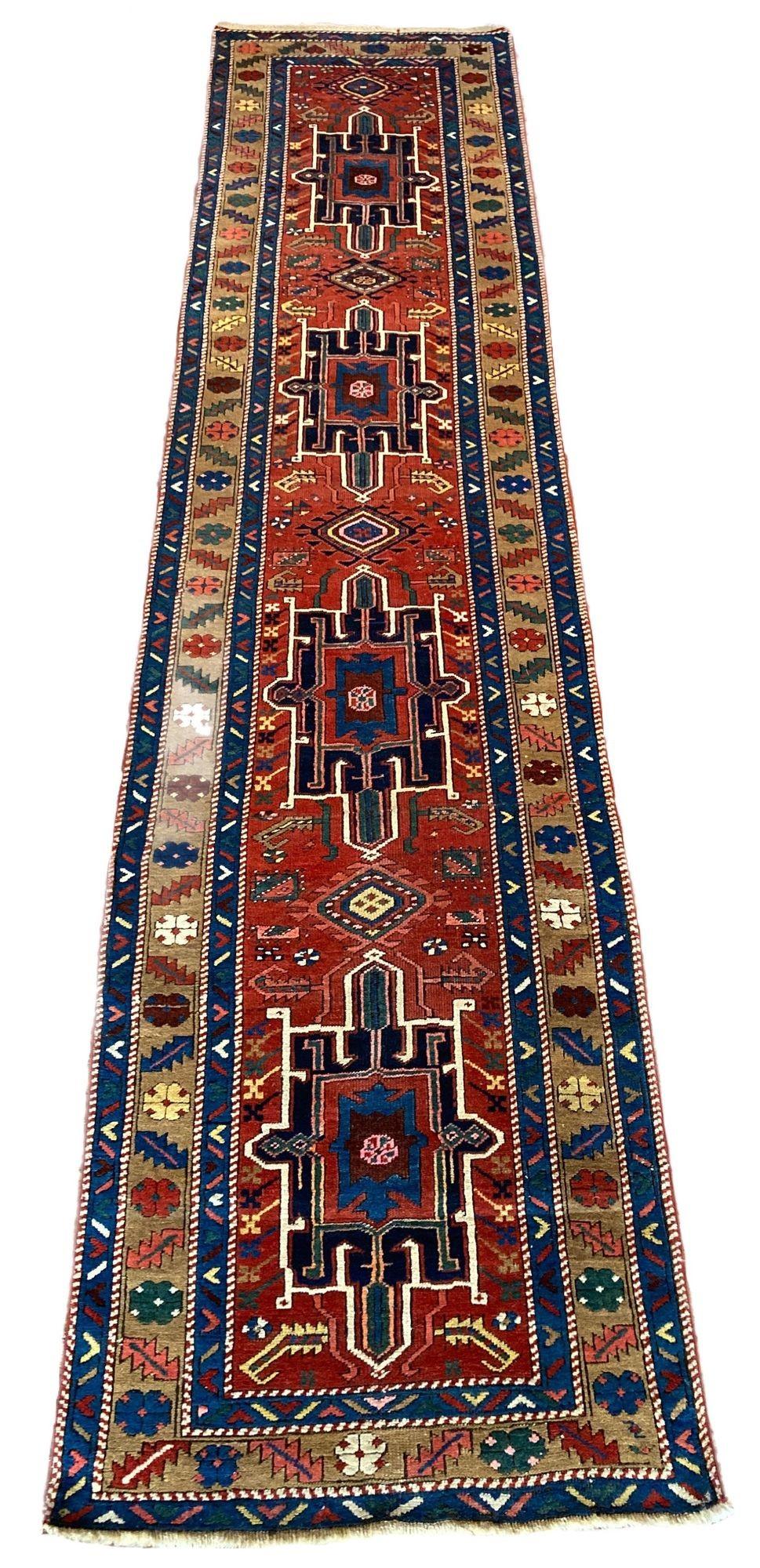 A beautiful antique Heriz runner, handwoven circa 1910. The design features four indigo medallions on a rich terracotta field and interesting camel border. Some very funky secondary colours of green, pink and gold!
Size: 4.18m x 0.96m (13ft 8in x