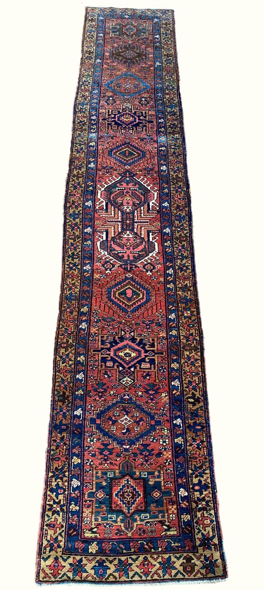 A fabulous antique Heriz runner, hand woven circa 1910. The design features numerous geometrical medallions on a terracotta field and camel border. Lovely secondary colours of pink, light blue and gold.
Size: 4.70m x 0.87m (15ft 5in x 2ft 10in)