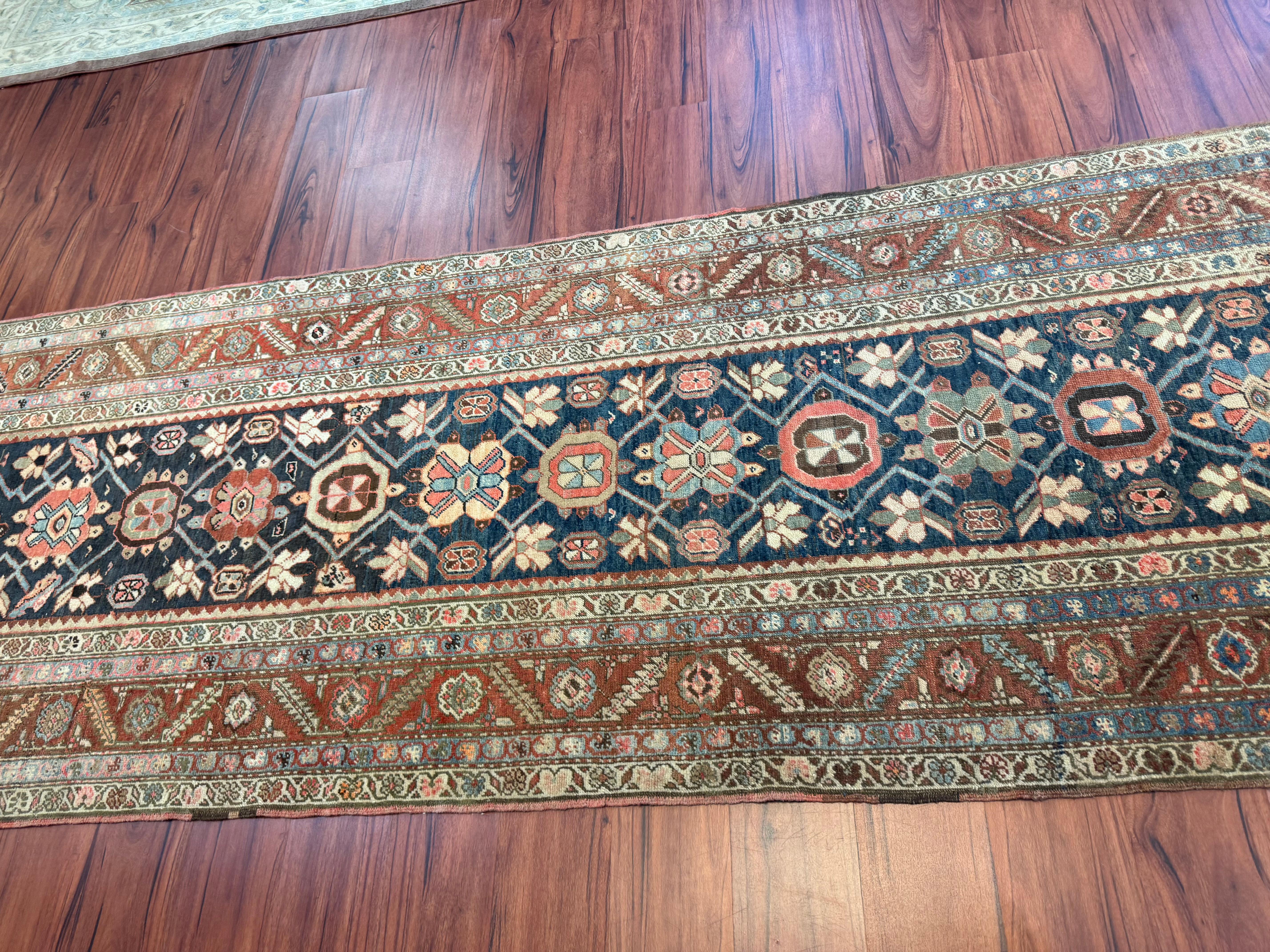 A stunning Antique Heriz runner rug that originated from Iran in the 1920s. This Rug is in excellent condition for its rich history and has only had minor repairs consistence with its age. 