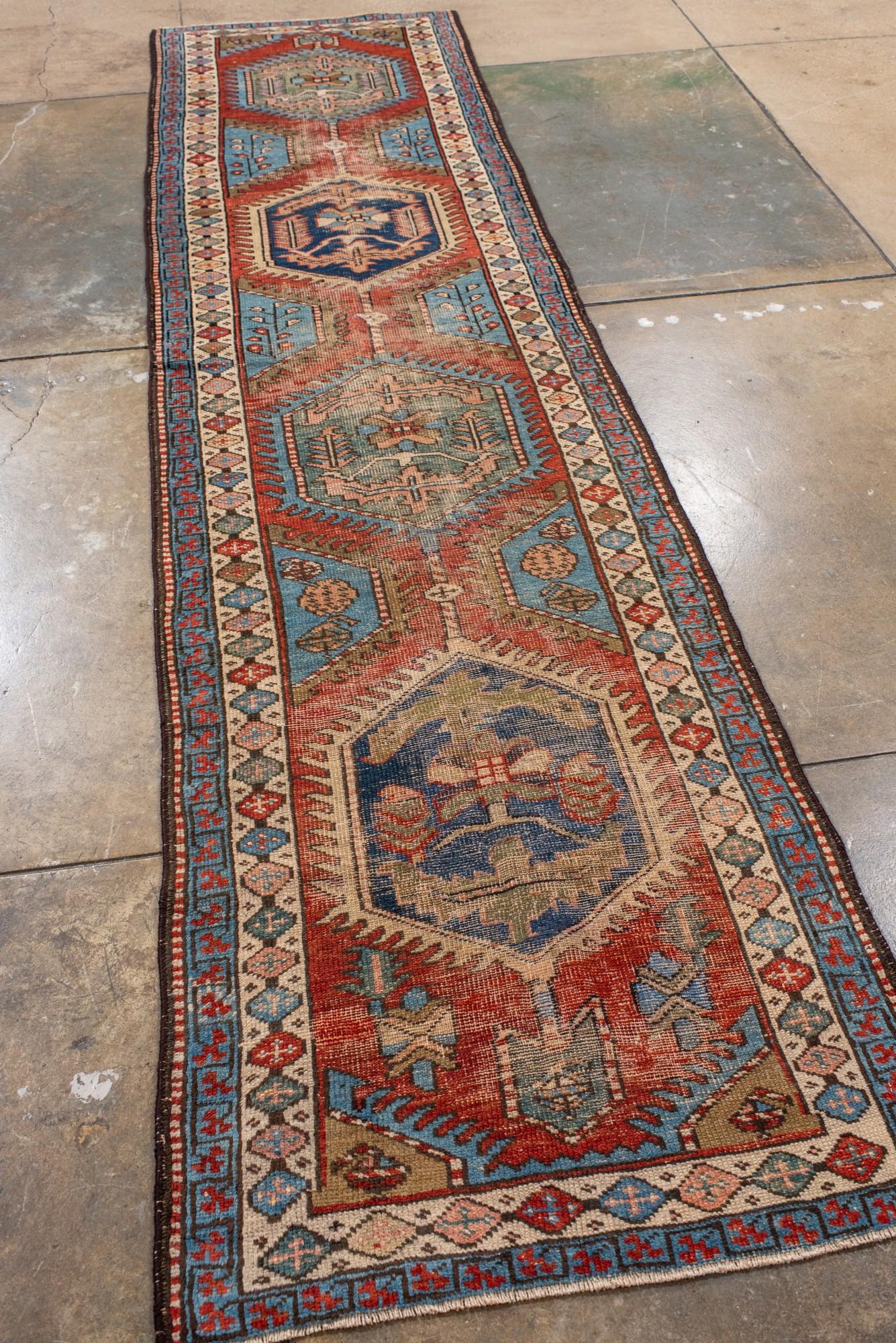 Persian Antique Heriz Runner with Hexagonal Medallions in Red and Blue For Sale