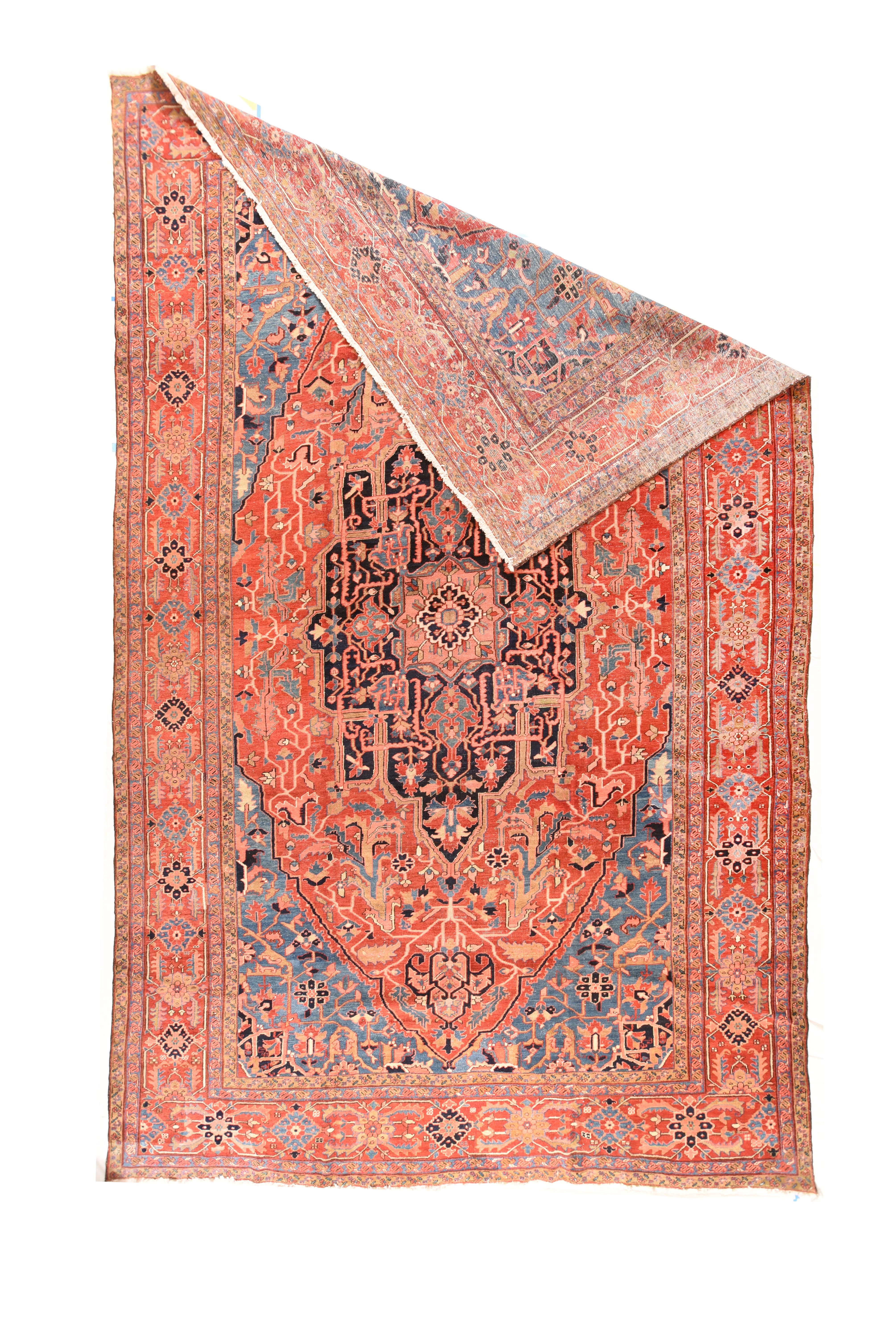 Antique Heriz Serapi Rug 11'7'' x 18'5''. This NW Persian village large carpet shows desirable abrashed sky blue corners properly [positioning a tomato madder field and a central have oval medallion with peripheral low points and flattened lobes.