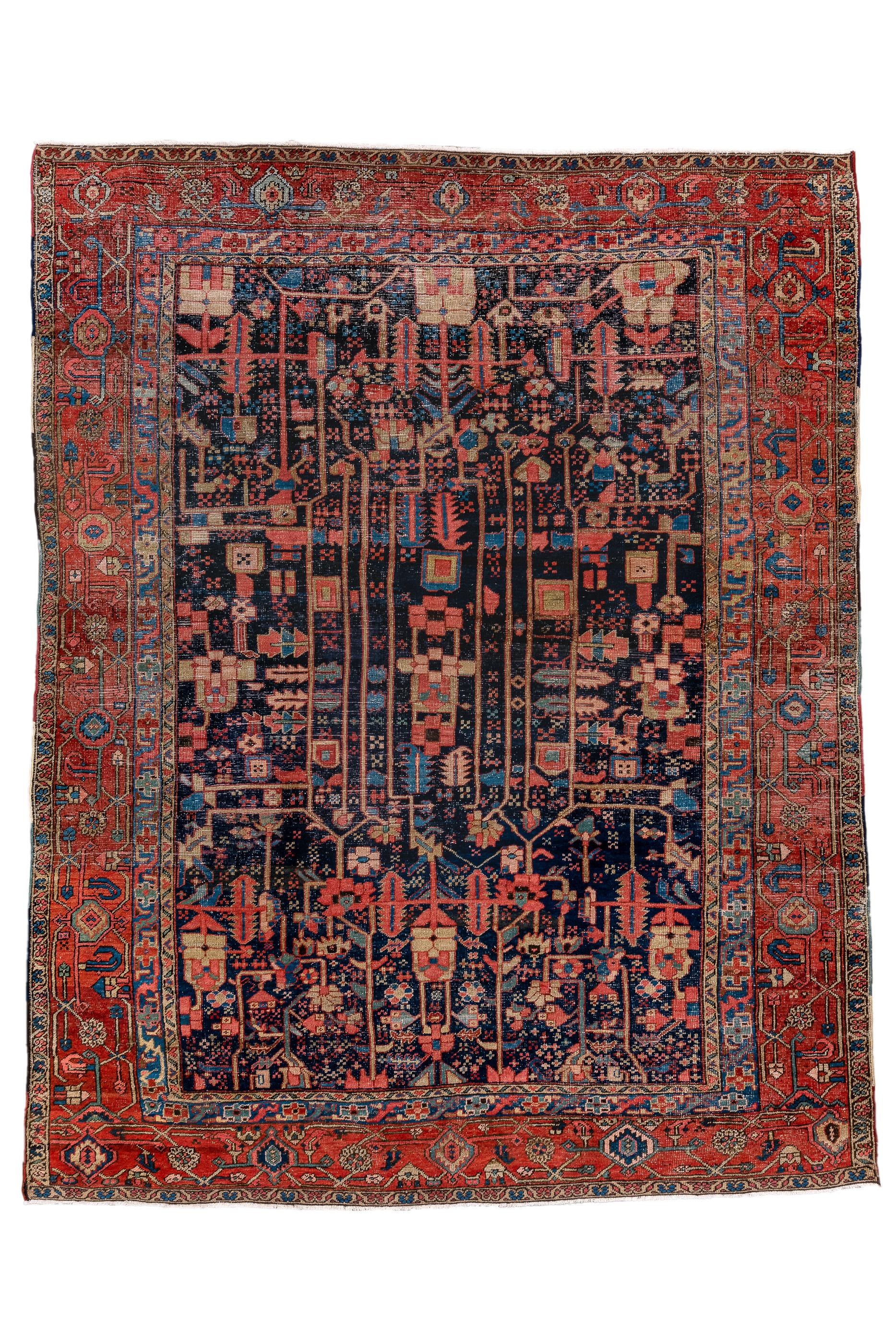 A very unusual piece with a dark blue indigo field displaying vertical bars forming reserves and decorated with rosettes, squared  flowerheads, barbed stiff leaves and other abstract devices.  The rust-red strip style main border  shows