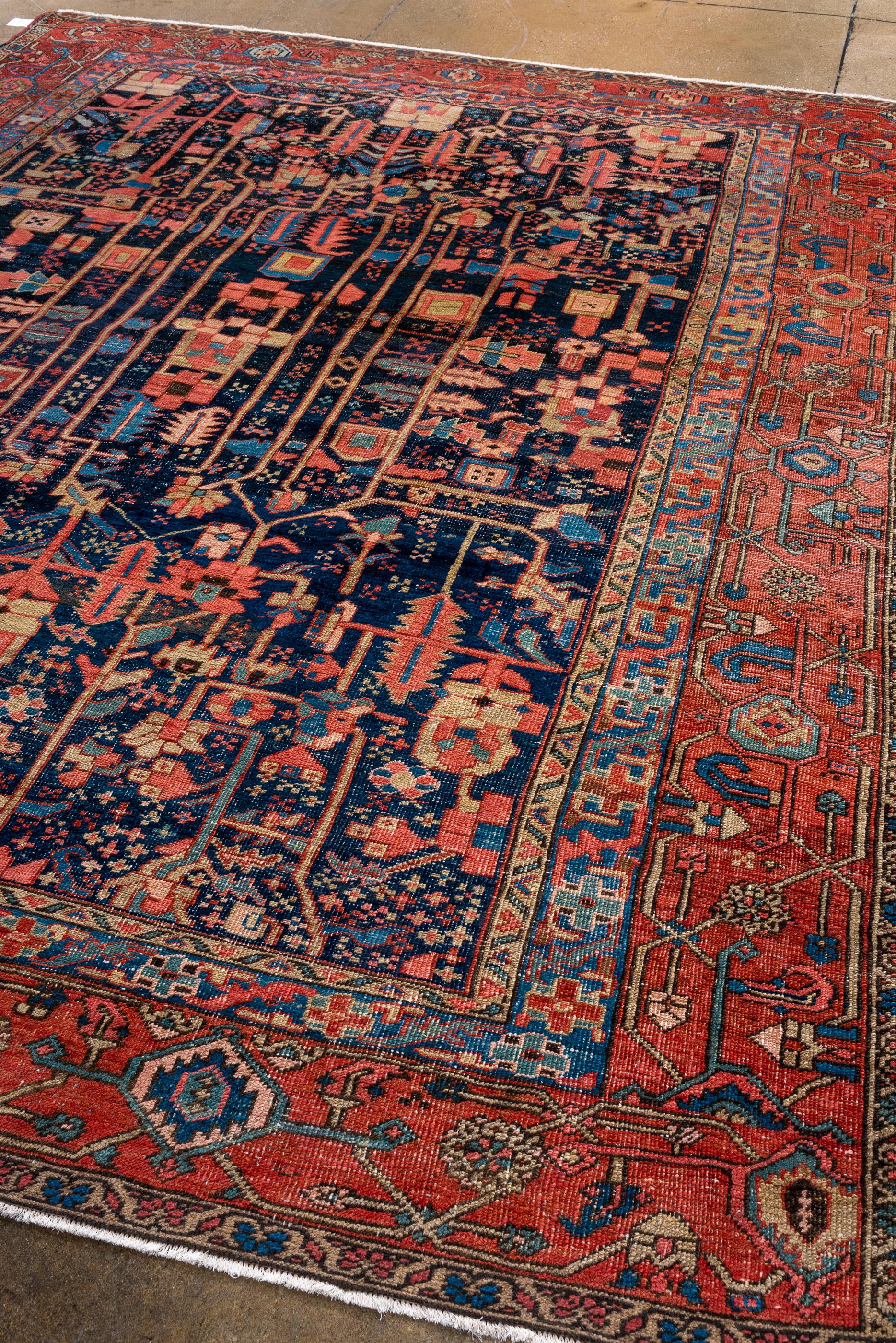 Persian Antique Heriz with Dark Blue Field and Unique Design For Sale