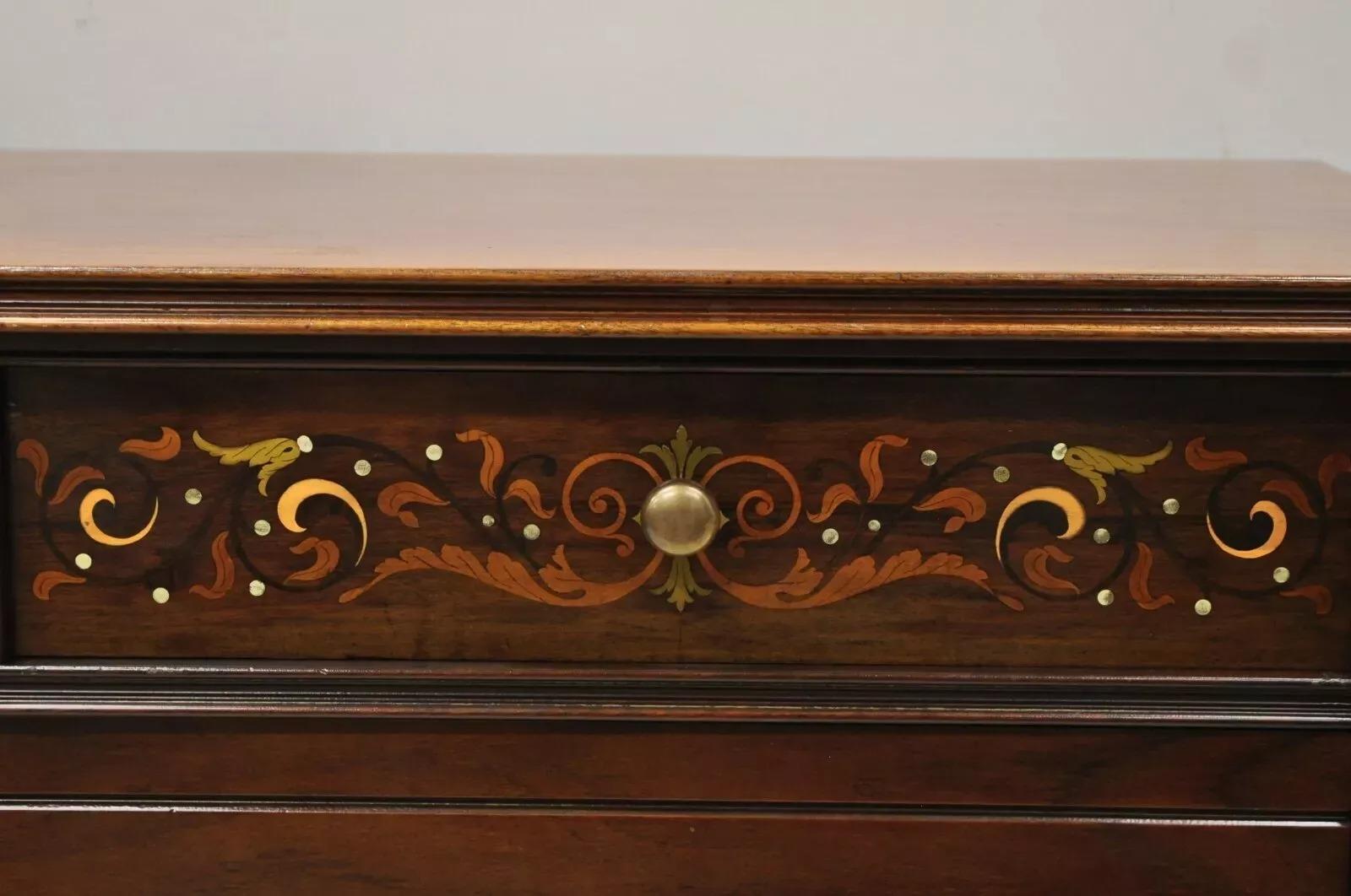 Antique Herts Brothers Edwardian Bronze & Satinwood Inlay Mahogany Chest Dresser. Item features brass and satinwood floral scrollwork inlay, brass/bronze capped feet, rolling casters, solid wood construction, beautiful wood grain, no key, but