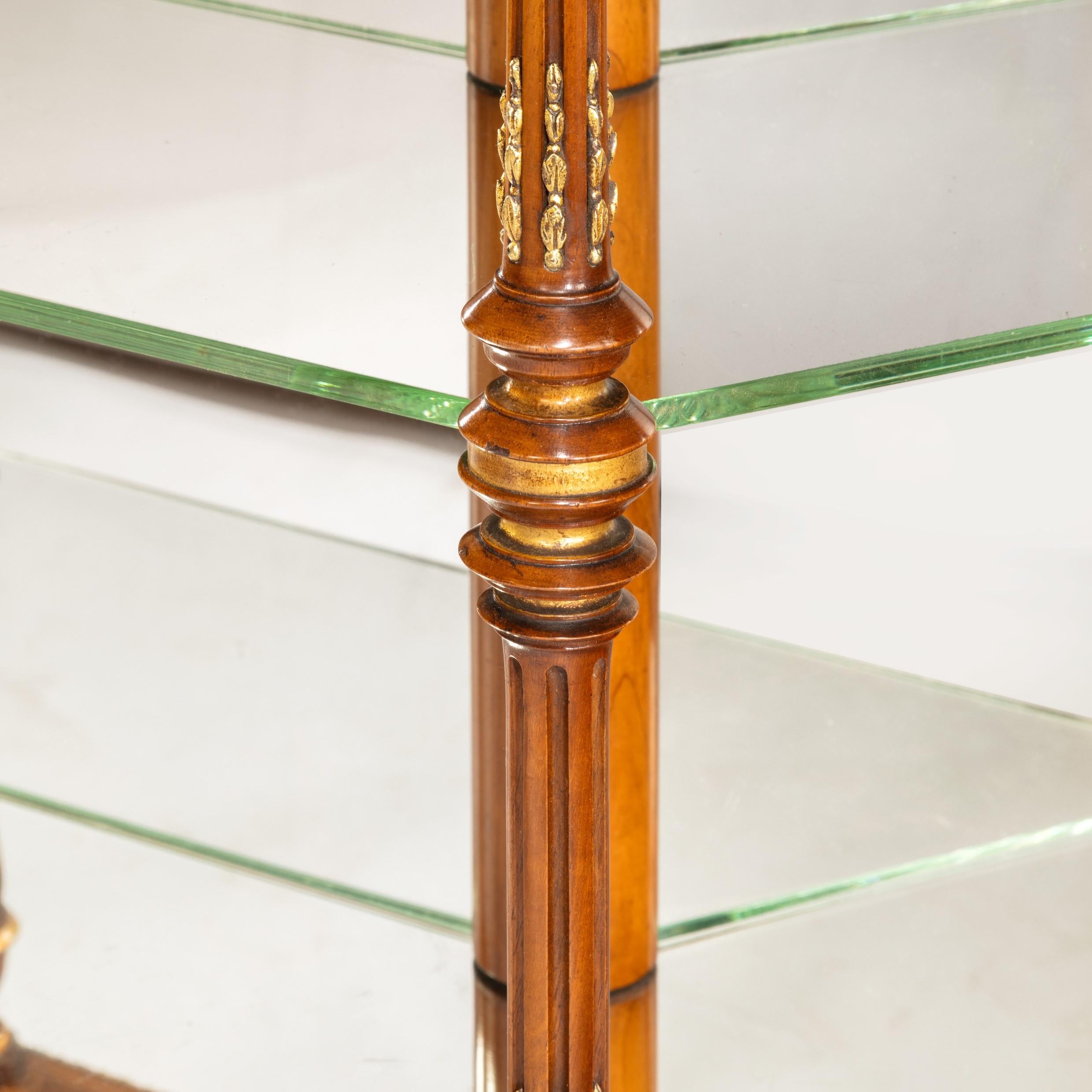 A rare hexagonal walnut display table attributed to Holland and Sons, of the finest quality with the original mirror-inset top and mirror-backed glass shelves, each corner with a turned parcel gilt solid walnut stop-fluted column, decorated with