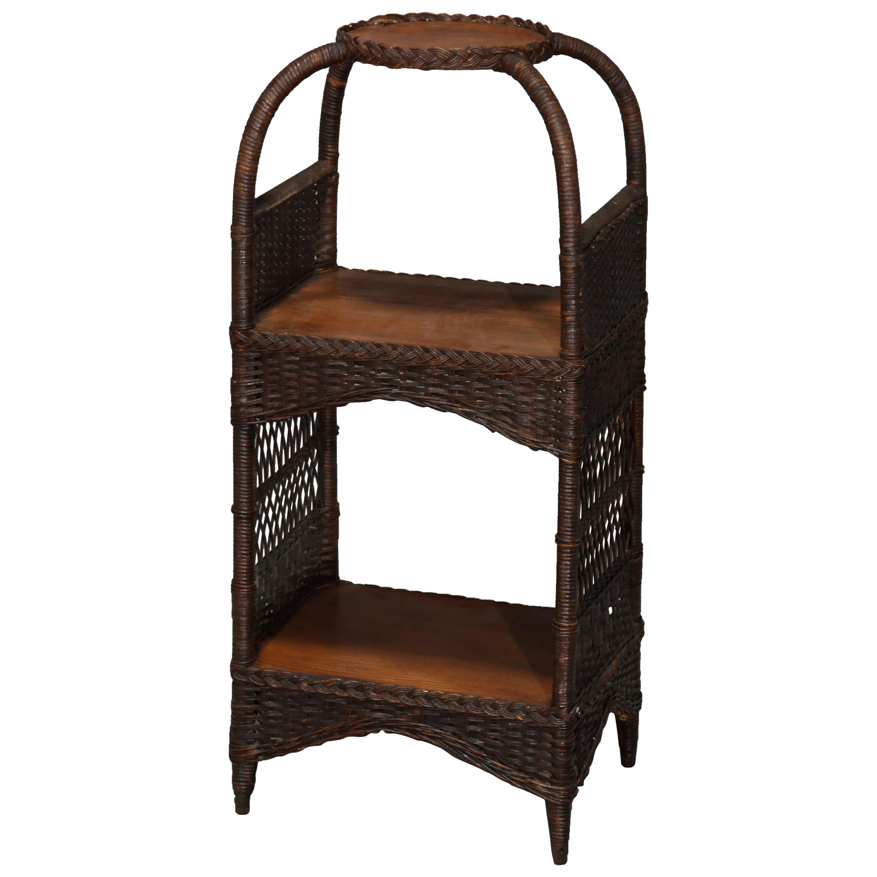 An antique plant stand by Heywood Wakefield offers oak frame with domed top and wicker sides, circa 1890.

Measures: 36.5