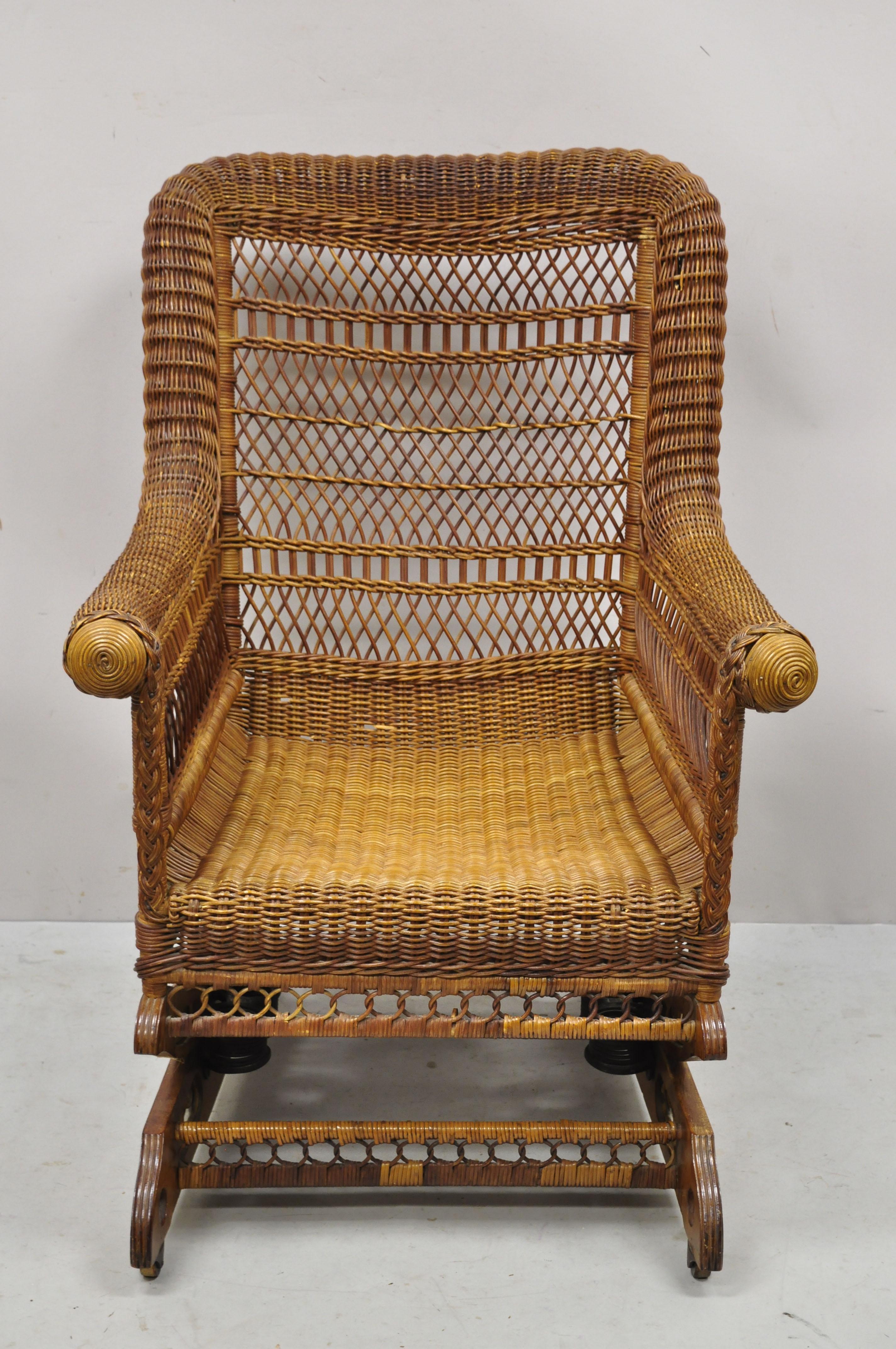 Antique Heywood Wakefield Woven Wicker Victorian platform rocker rocking chair. Item features carved wood platform rocker base with rolling casters, ornate woven wicker wrapped frame, rolled arms, remnants of original label, very nice antique item,