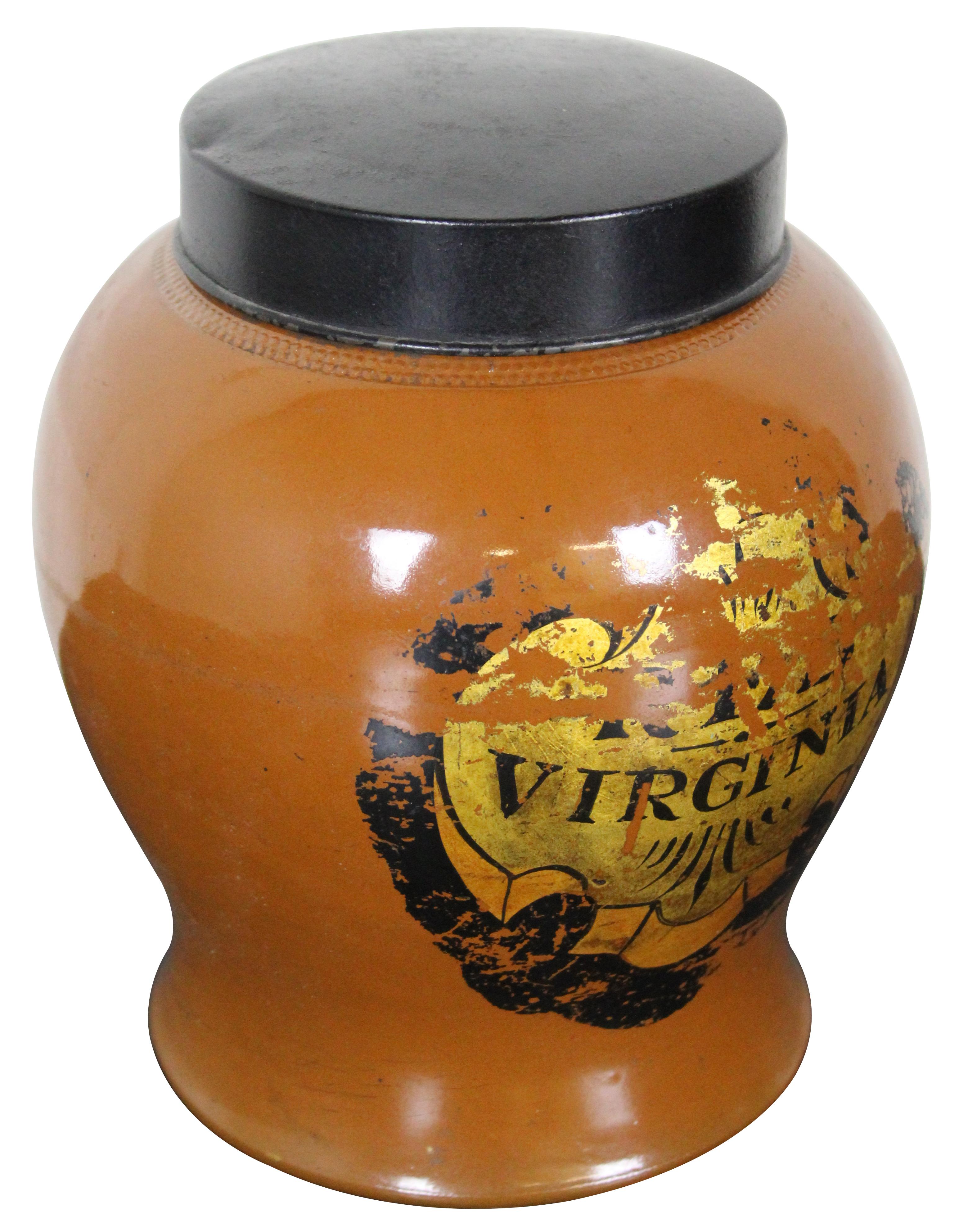 Rare antique English Victorian apotheary tobacco jar / tea caddy produced by H. F. & S London, in an orange-brown glazed pottery with Virginia on the front, and a black metal lid.
 