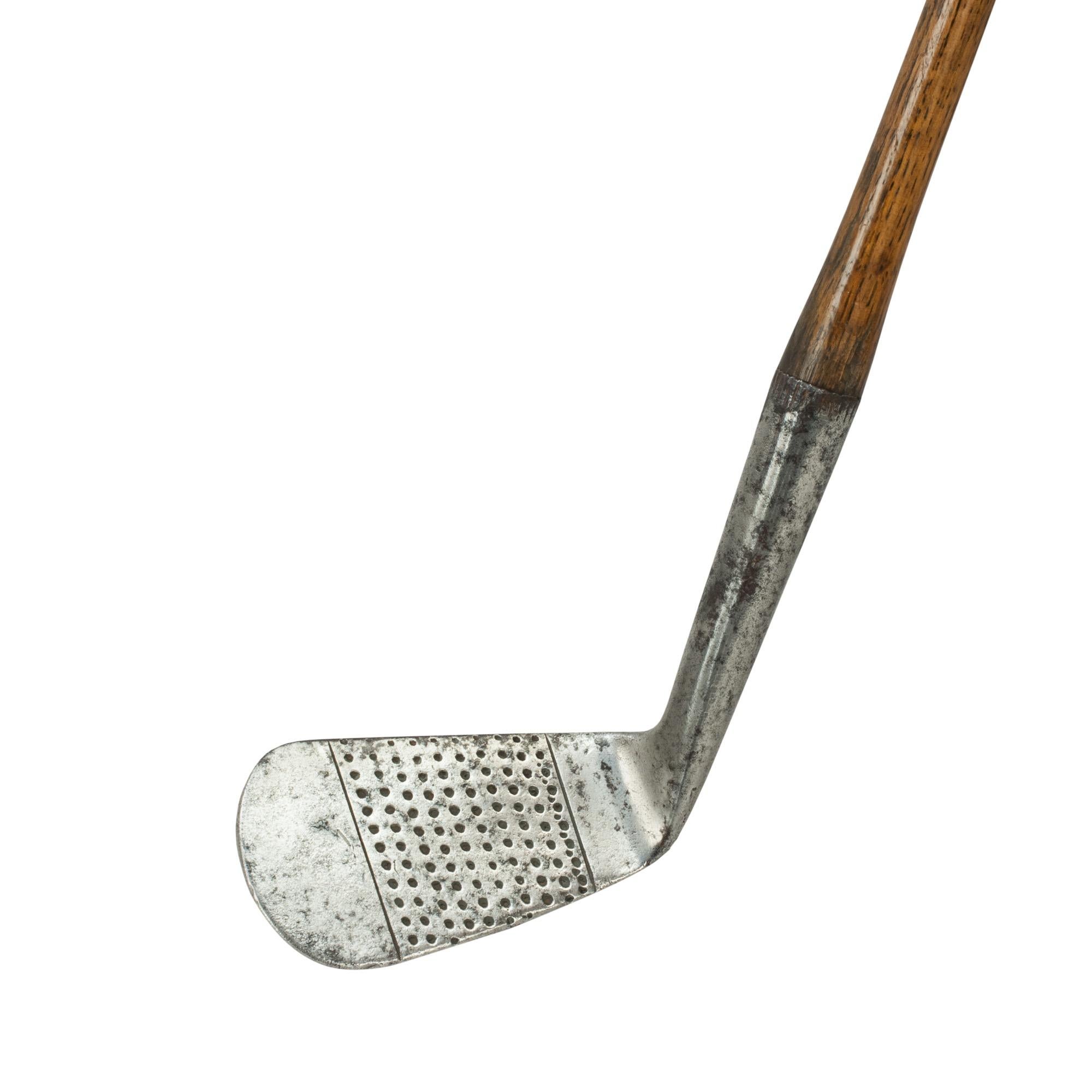 Vintage hickory golf club, iron, by Tom Stewart, St Andrews.
A fine and nicely weighted dot punched faced lofting iron by Tom Stewart of St. Andrews. The hickory shaft with polished leather grip, the rear of the club head marked with Stewart's