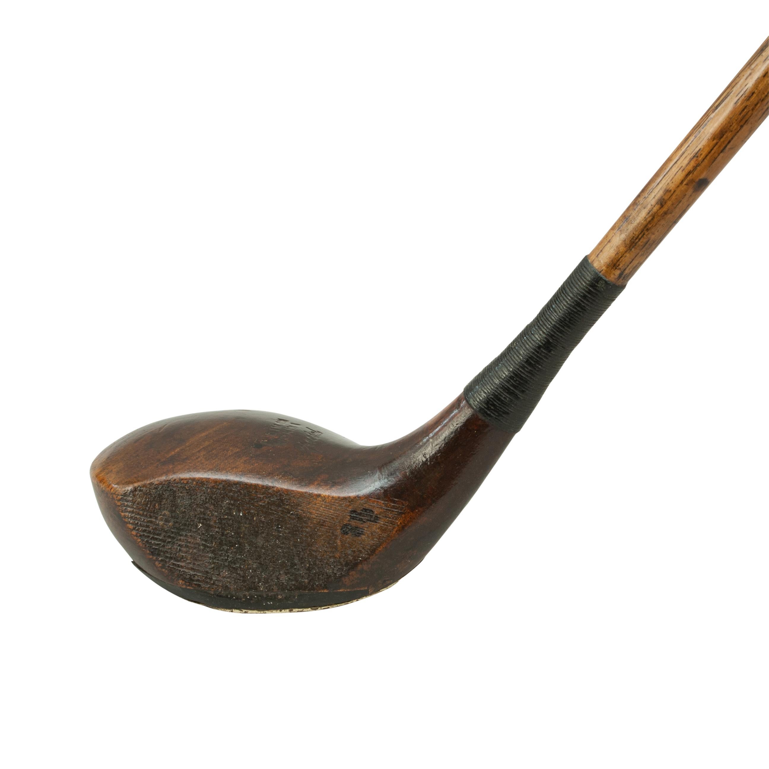 Golf club, hickory spoon, A. Dimon, Woking.
A good persimmon wood Brassie by A. Dimon, Woking. The club has a hickory shaft with a polished leather grip. The head is marked 'A. Dimon, Woking, Special' and has a lead weight to the rear, Horn sole