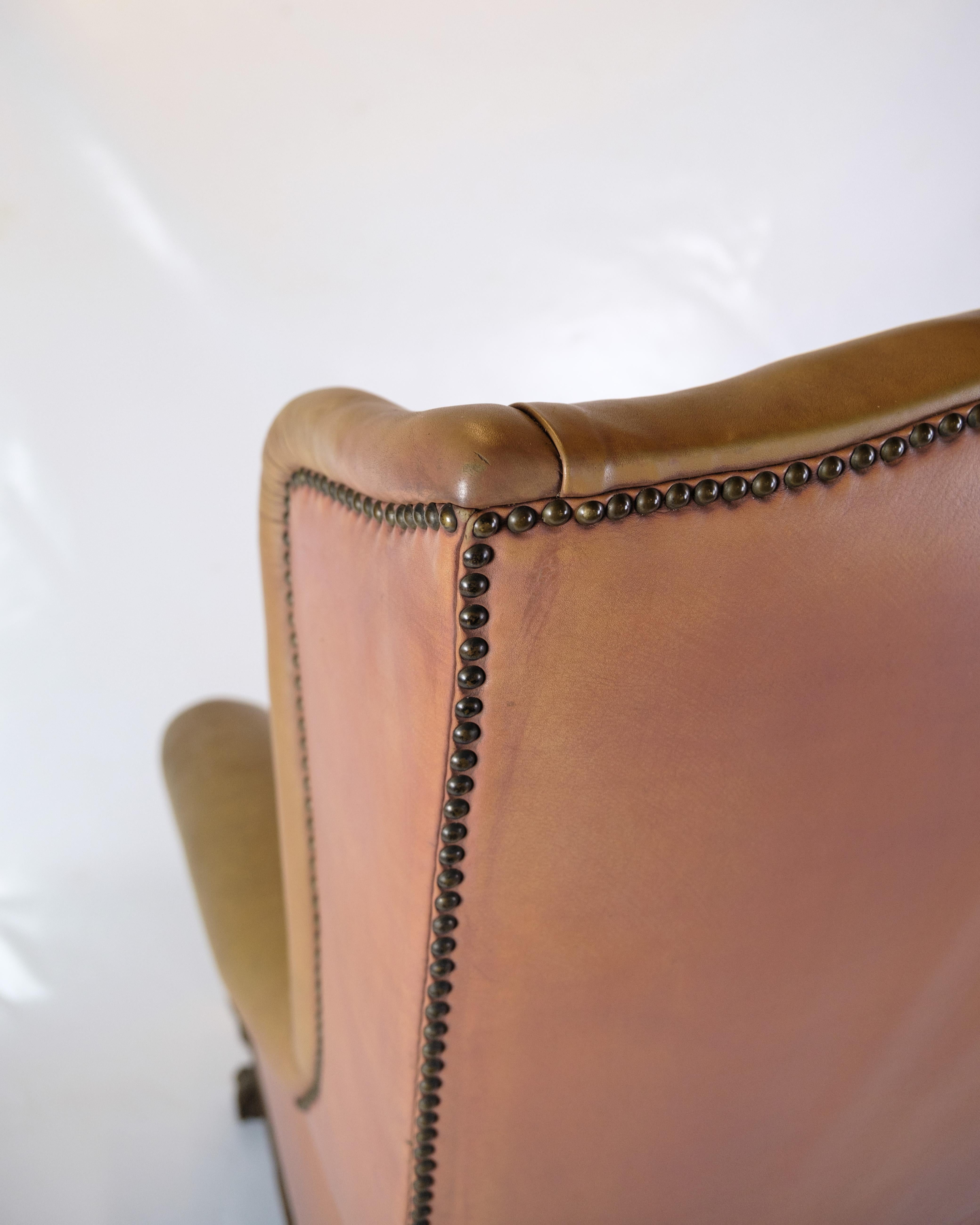 Early 20th Century Antique High Flap Chair, Chesterfield Style Made In Brown Leather From 1920s For Sale