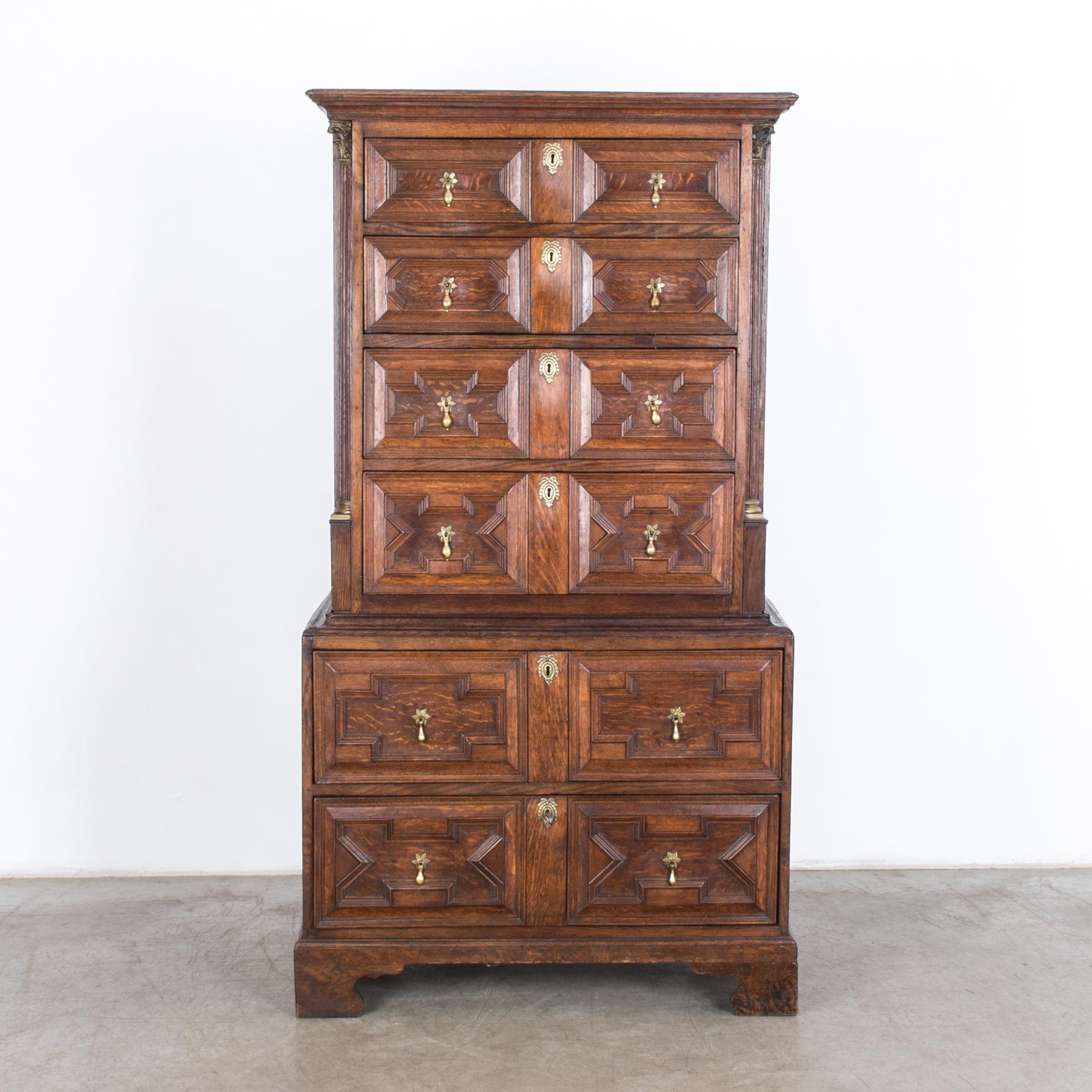A tall dresser drawer cabinet from the UK, circa 1900. Fantastic quality in a simple and elegant neoclassical style. A typical Regency style piece rendered in rich textured oak; the original finish has been restored and stabilized in our atelier.