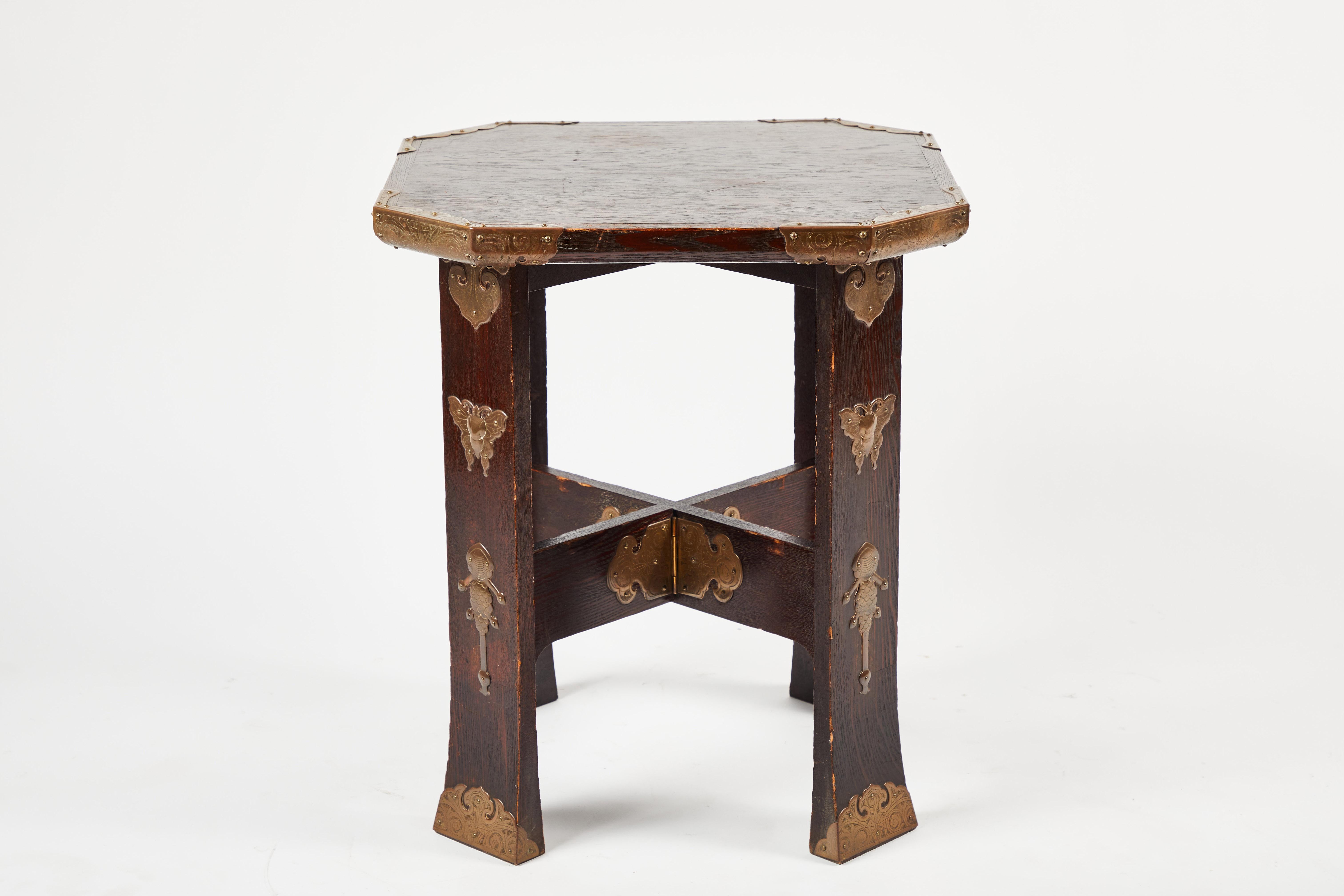 Exceptionally rare and beautiful antique side table from the Korean peninsula. Finely carved removable octagonal wooden top with cast brass end caps. X Base support with additional decorative brass details; legs have decorative brass butterflies,