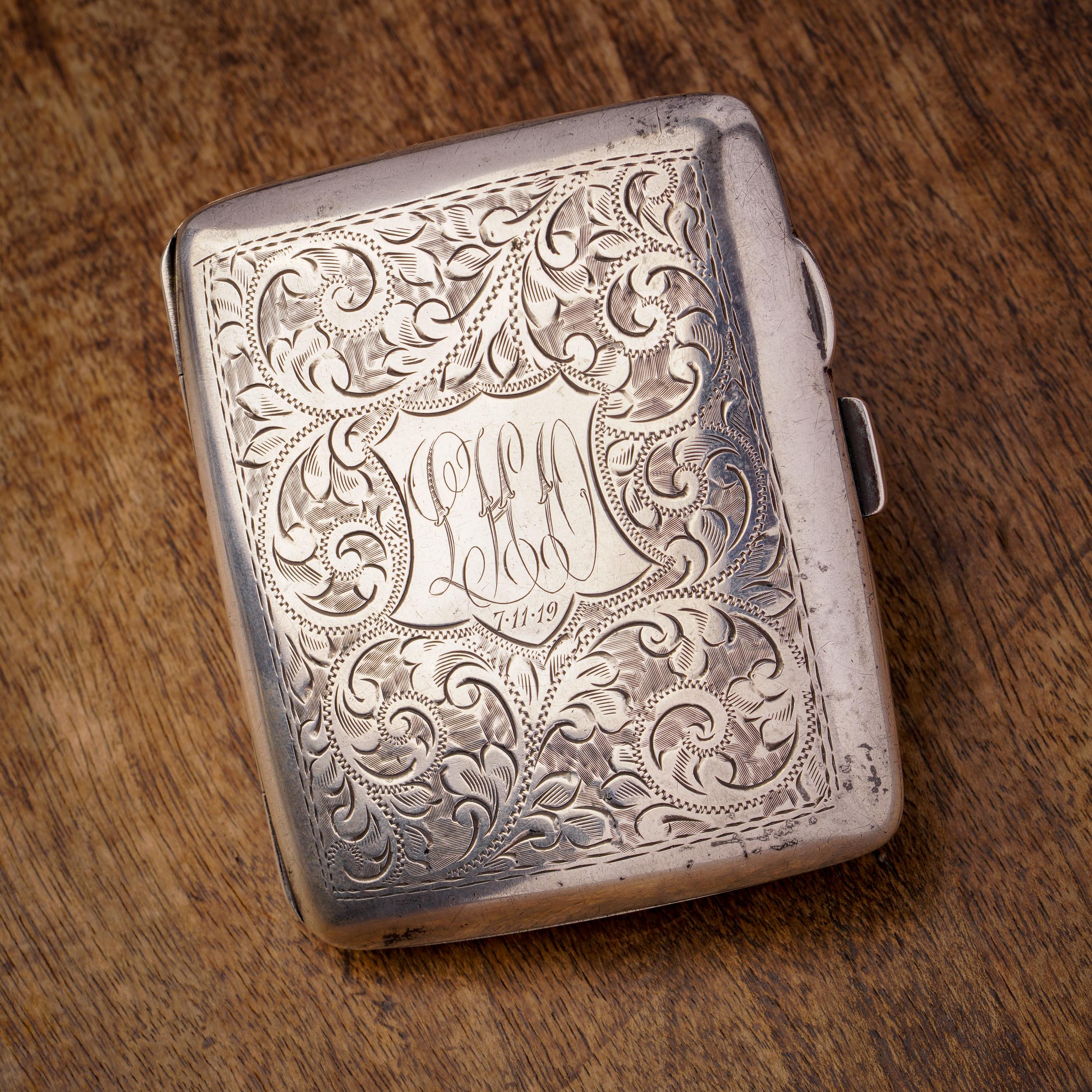 This exquisite cigarette case, crafted from 925 sterling silver, exudes intricate detailing and sophistication. Adorned with the monogram 'LHO' and inscribed with the date '7.11.19', it adds a personalized touch and historical significance to its