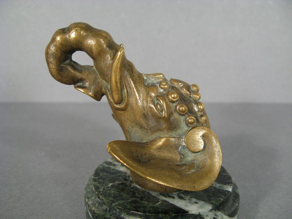 This exquisite bronze paperweight, crafted in the late 19th or early 20th century, showcases the intricate artistry of the era. Depicting a majestic Hindu elephant head, the paperweight exudes a sense of tranquility and wisdom, making it a