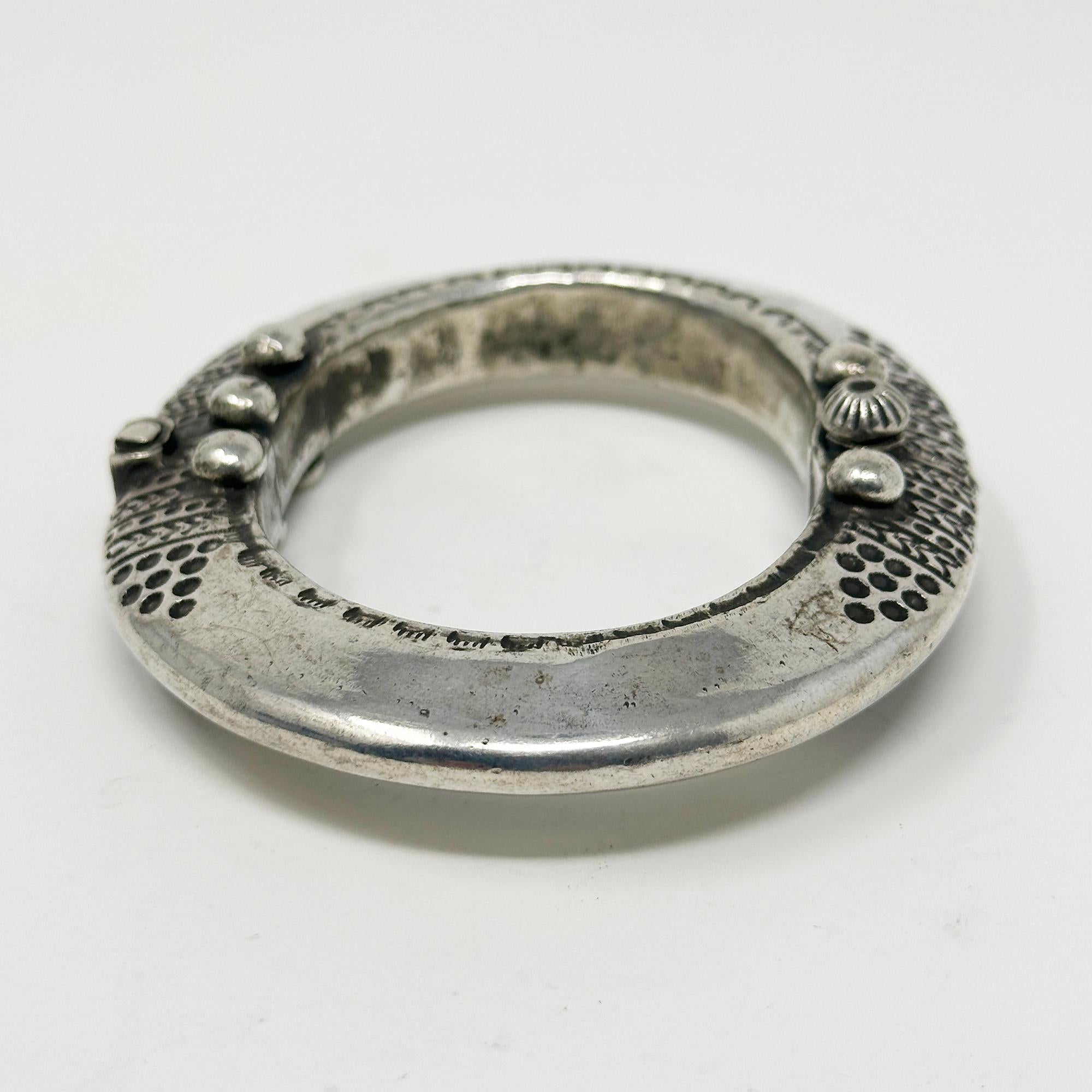 Antique Hinged Silver Bracelet from South India

A relatively scarce silver hinged bracelet possibly from the Lakshadeep Islands in South India, it opens with a pin - please see photo. The interior diameters are 2.5 and 2 inches. and it's about .5