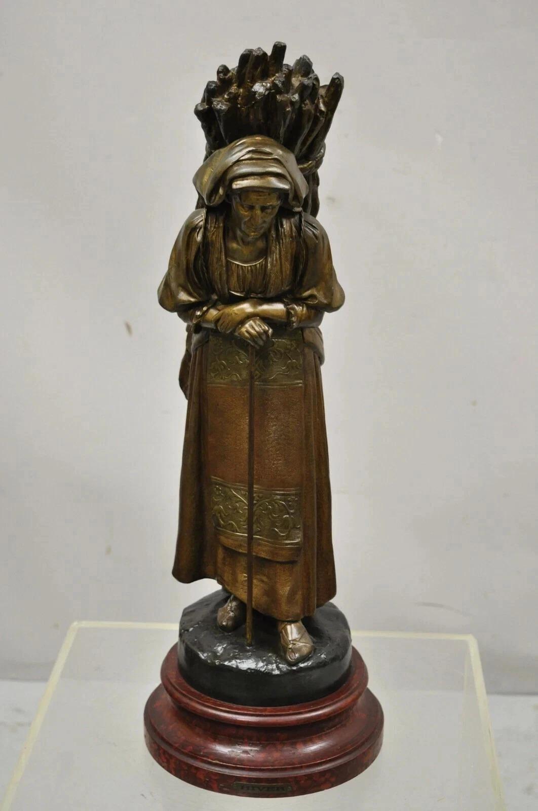 Antique French Spelter Sculpture Statue of Woman Carrying Bundle of Sticks, Hiver. L'oggetto presenta una figura di donna in fusione di metallo spelta che trasporta un fascio di bastoni sulla schiena, una base in legno dipinto, un'etichetta in