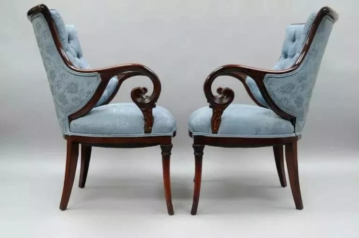 Antique Hollywood Regency Grosfeld House Mahogany & Rosewood Arm Chairs - a Pair. Item features solid carved mahogany wood frames, rosewood inlay to top rail with solid brass inlay, scrolling arms, tapered saber legs, blue tufted upholstery and