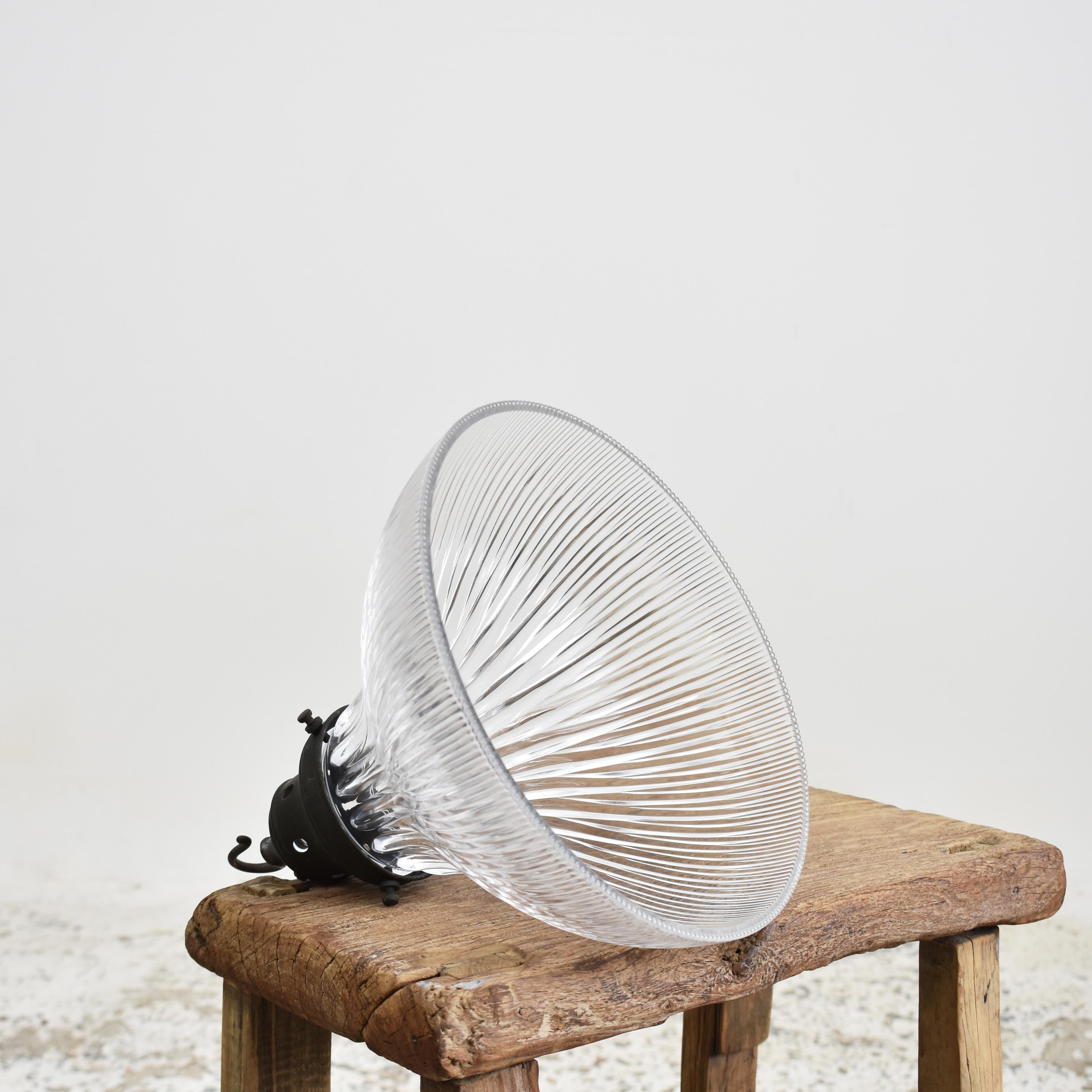 Antique Glass Holophane Pendant Light – I

A vintage bell shaped glass prismatic pendant light shade which looks great both lit and unlit. The light has retained its original brass gallery, which has some great age and painta stamped with the makers