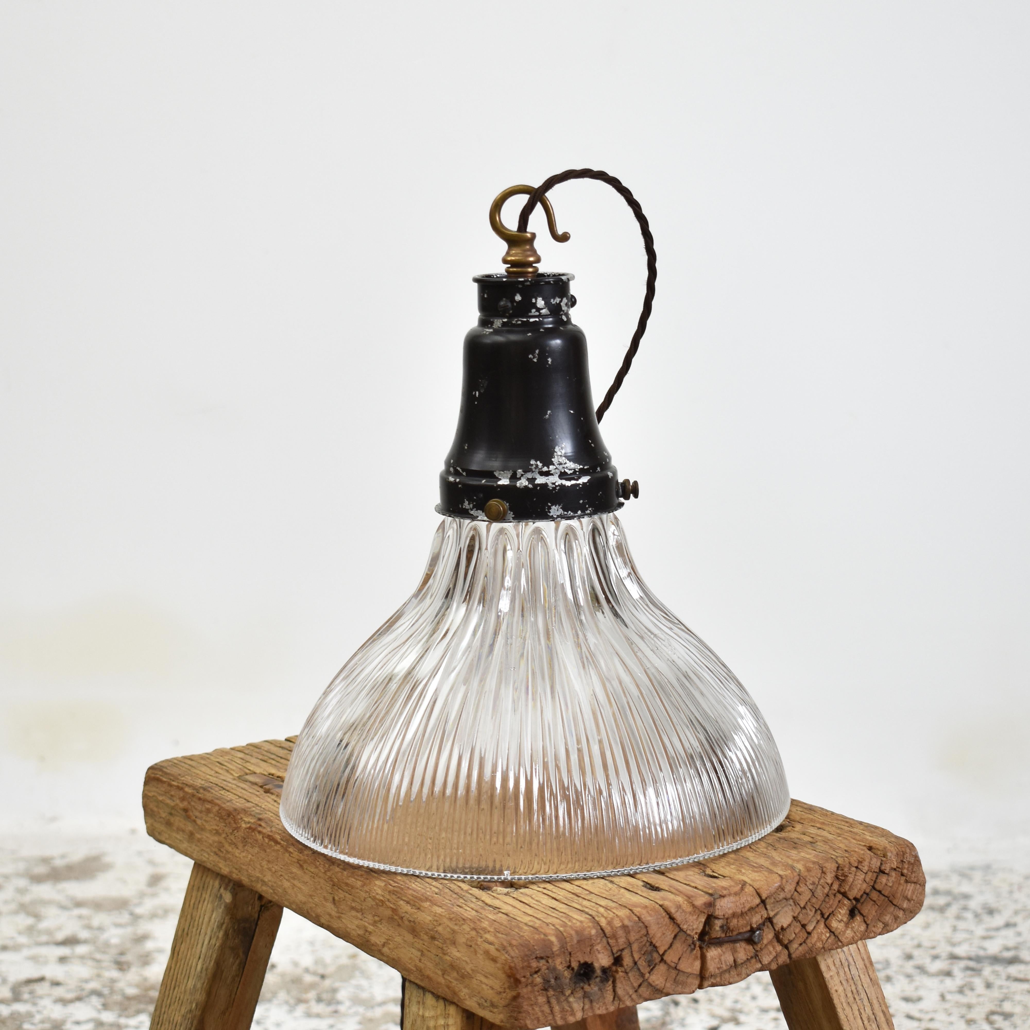 Antique Glass Holophane Pendant Light – J

A vintage bell shaped glass prismatic pendant light shade which looks great both lit and unlit. The light has retained its original gallery, which has some great age and patina stamped with the makers mark