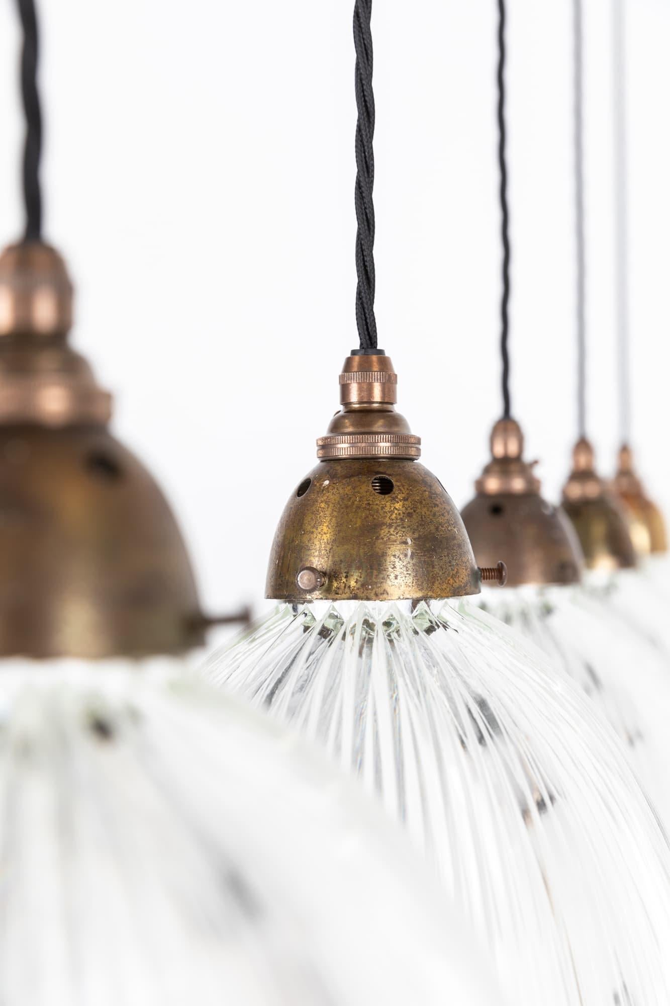 

Elegantly formed prismatic glass pendant lights made in England by Holophane. c.1930

Glass lights with Holophane stamp to the rim of each shade. Period domed brass galleries. Price is per lamp.

Rewired with 1m of black twist flex.
