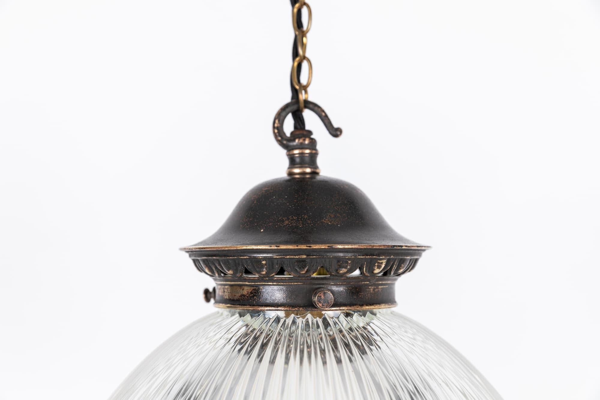 

Beautiful 'Reflector-Refractor' pendant light made in England by Holophane. c.1920.

Two-part prismatic glass reflector supported by original aged brass gallery bearing the Holophane stamp. Glass parts also stamped Holophane.

Rewired with 1m