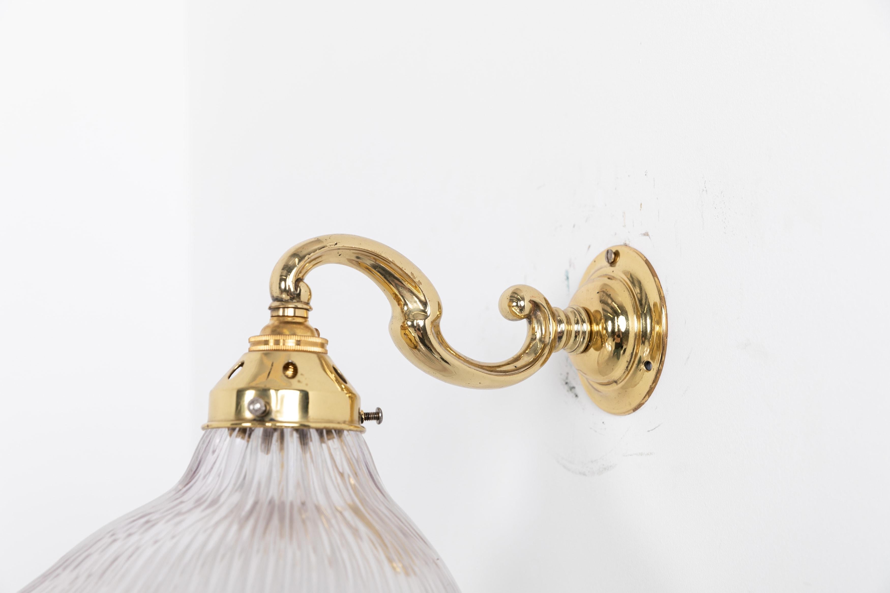 A stunning wall brass wall lamp made in England by Holophabe, circa 1920

Polished brass swan-neck wall mount with an elliptical prismatic glass Holophane 'Stiletto' shade. Glass stamped Holophane to the rim.

Rewired to connect to