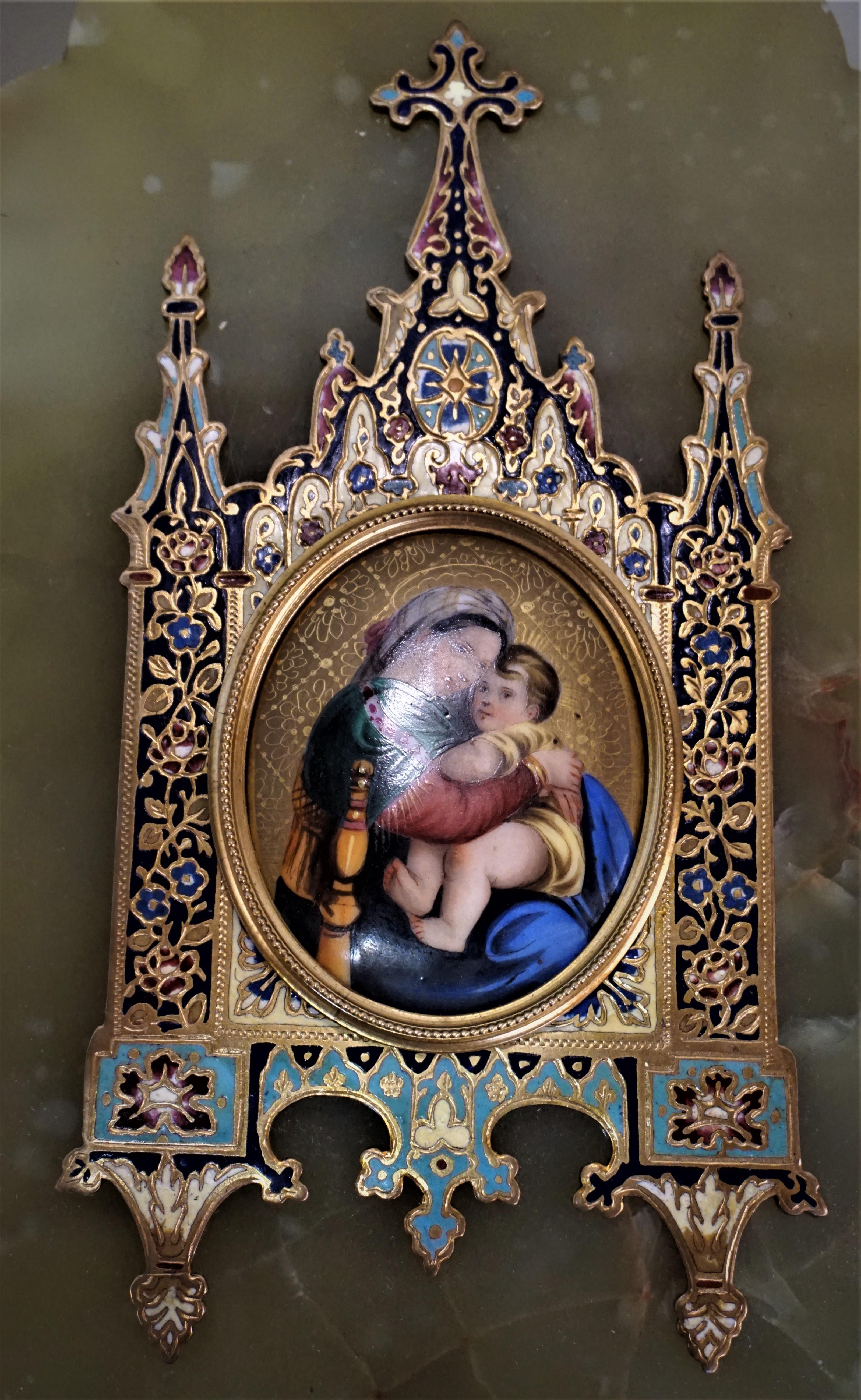 The miniature painting on porcelain of Madonna and child or Madonna della sedia after painting by the Italian Renaissance artist Raphael and housed in bronze enamel, champleve frame over green onyx.