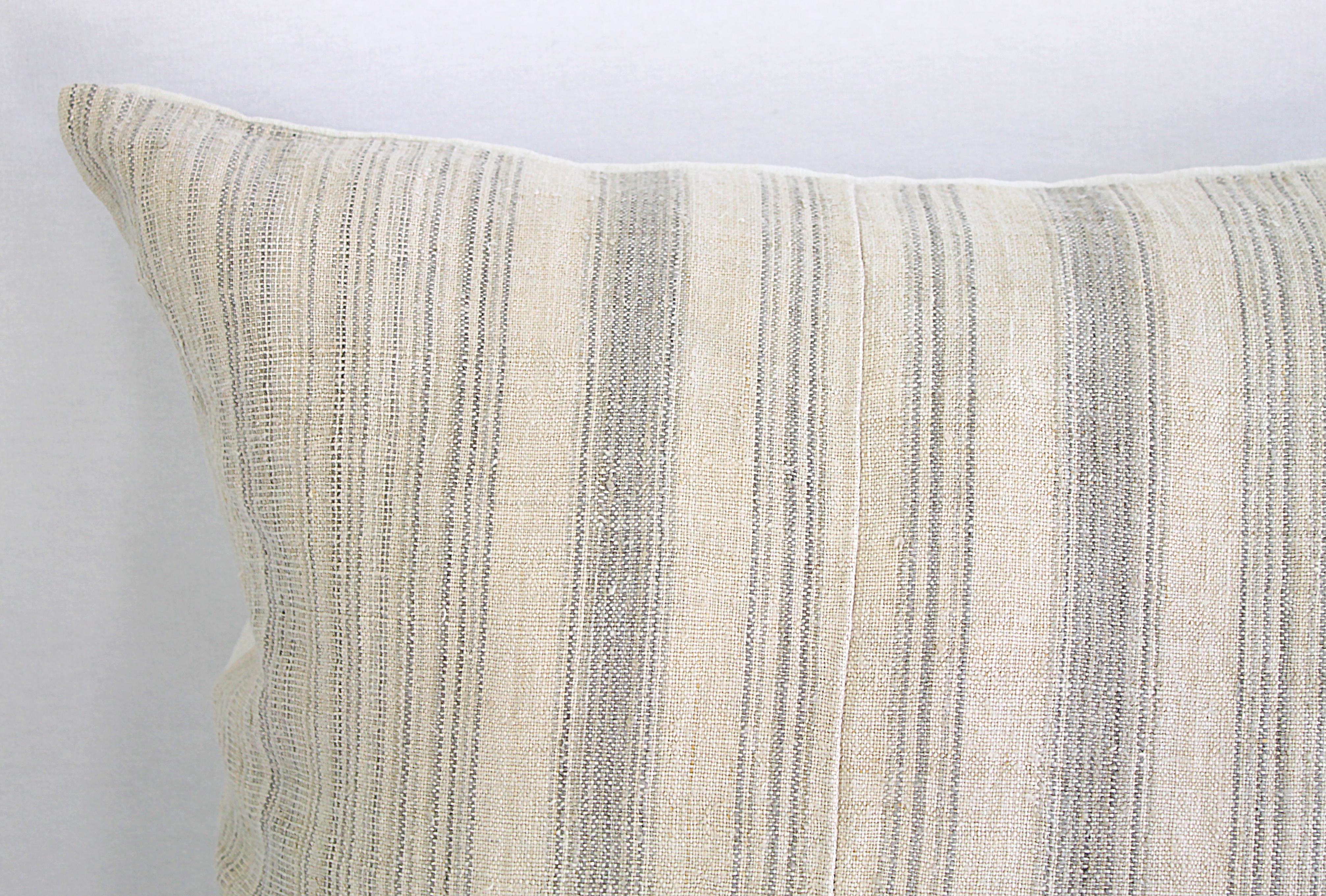 Antique homespun linen and striped grain sack pillow
Light grey and creamy white striped grain sack front, the backside is finished in a off white natural French linen. The front of the pillows are made from 19th century homespun linen, and the