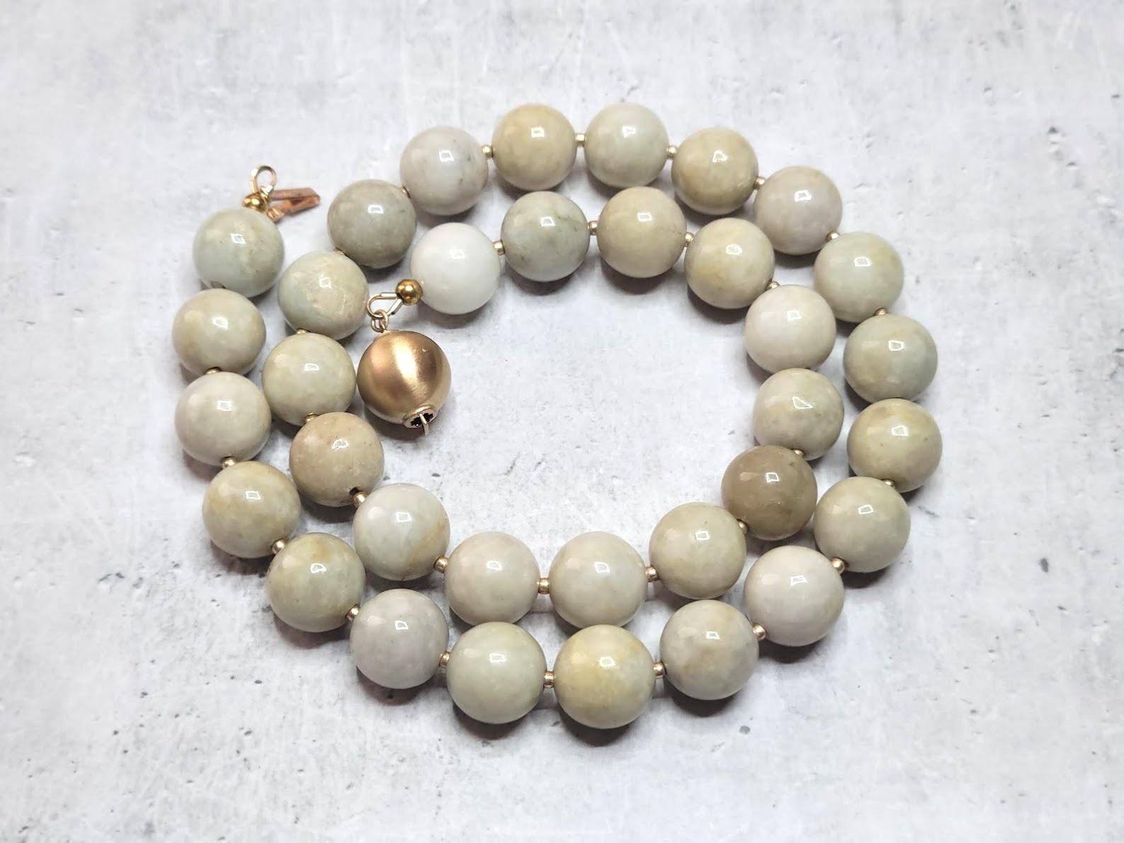 The jade beads on this necklace are undyed, untreated natural creamy honey tan jades of excellent quality. The jade beads are old. Each bead is cut and polished by hand. Presumably, the beads belong to the period of the Qing Dynasty (1644 -