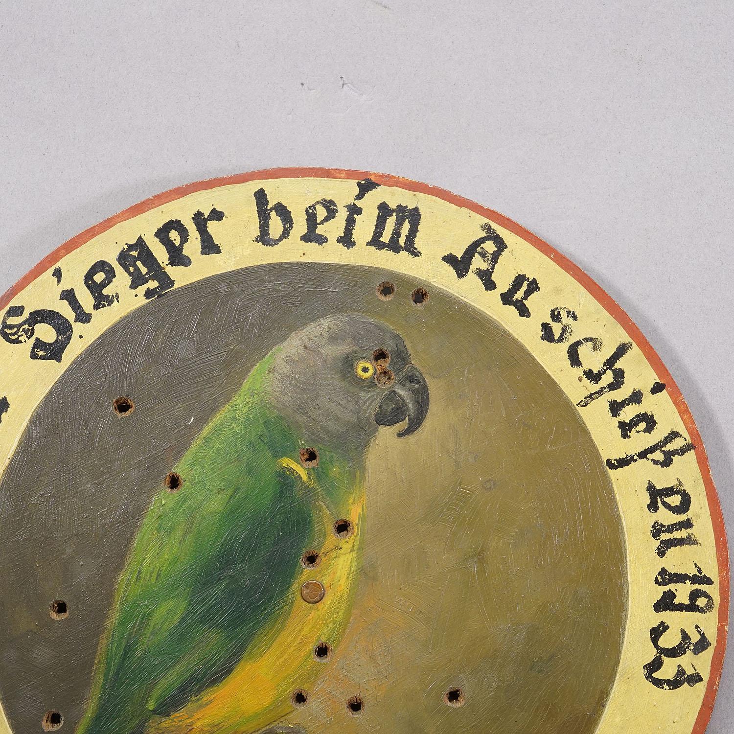 Antique Honor Shooting Target with Black-Headed Parrot, Germany 1933

An antique honor shooting target. The wooden target is decorated with a colorful painting showing a black-headed parrot. It features the handwritten inscription of the winner on