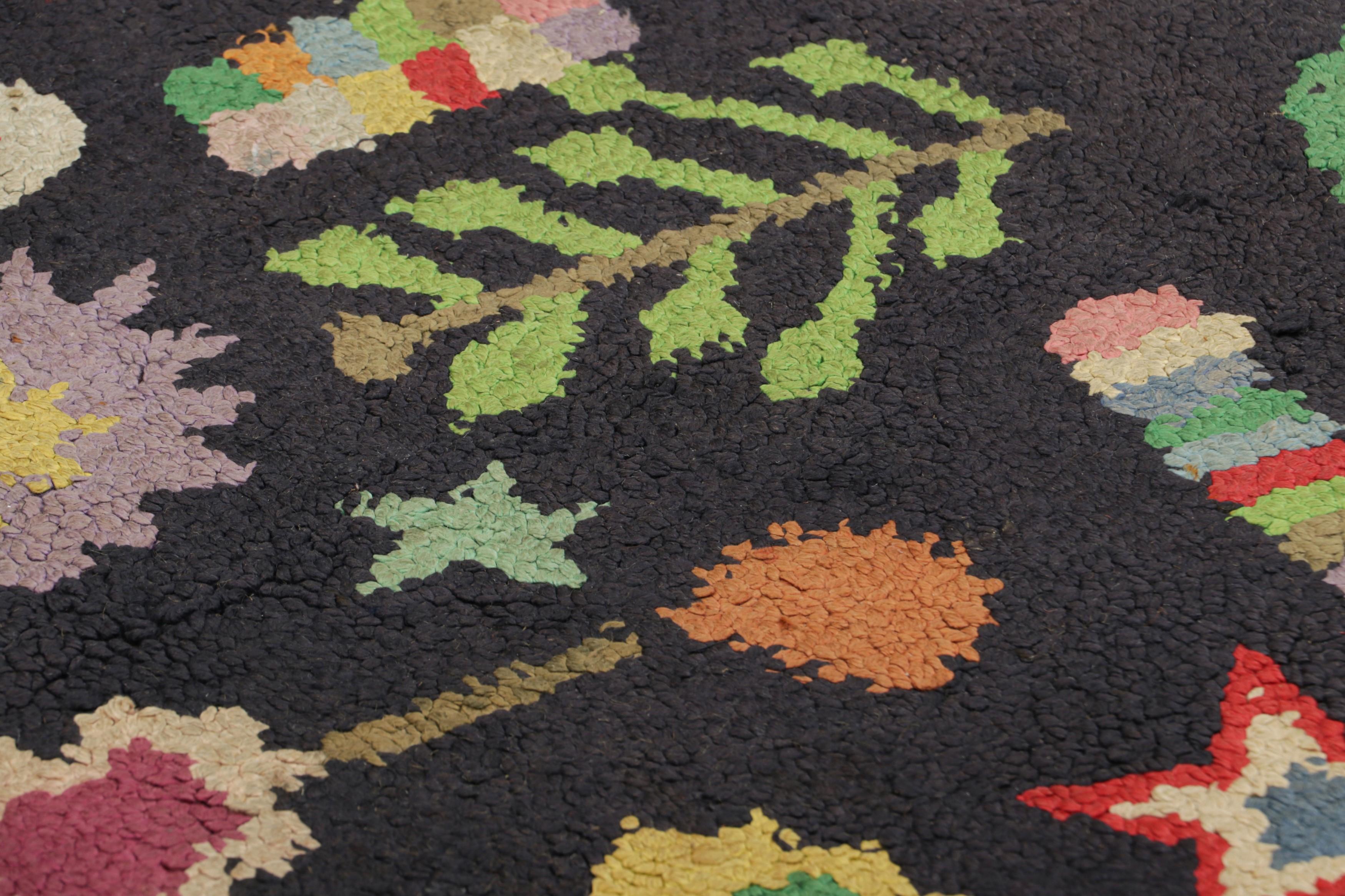 Handmade in wool and originating circa 1920-1930, this 3x3 antique rug is a rare and exciting new curation in Rug & Kilim’s collection of American hooked rugs.

On the Design: 

A borderless black field features polychromatic motifs inspired with a