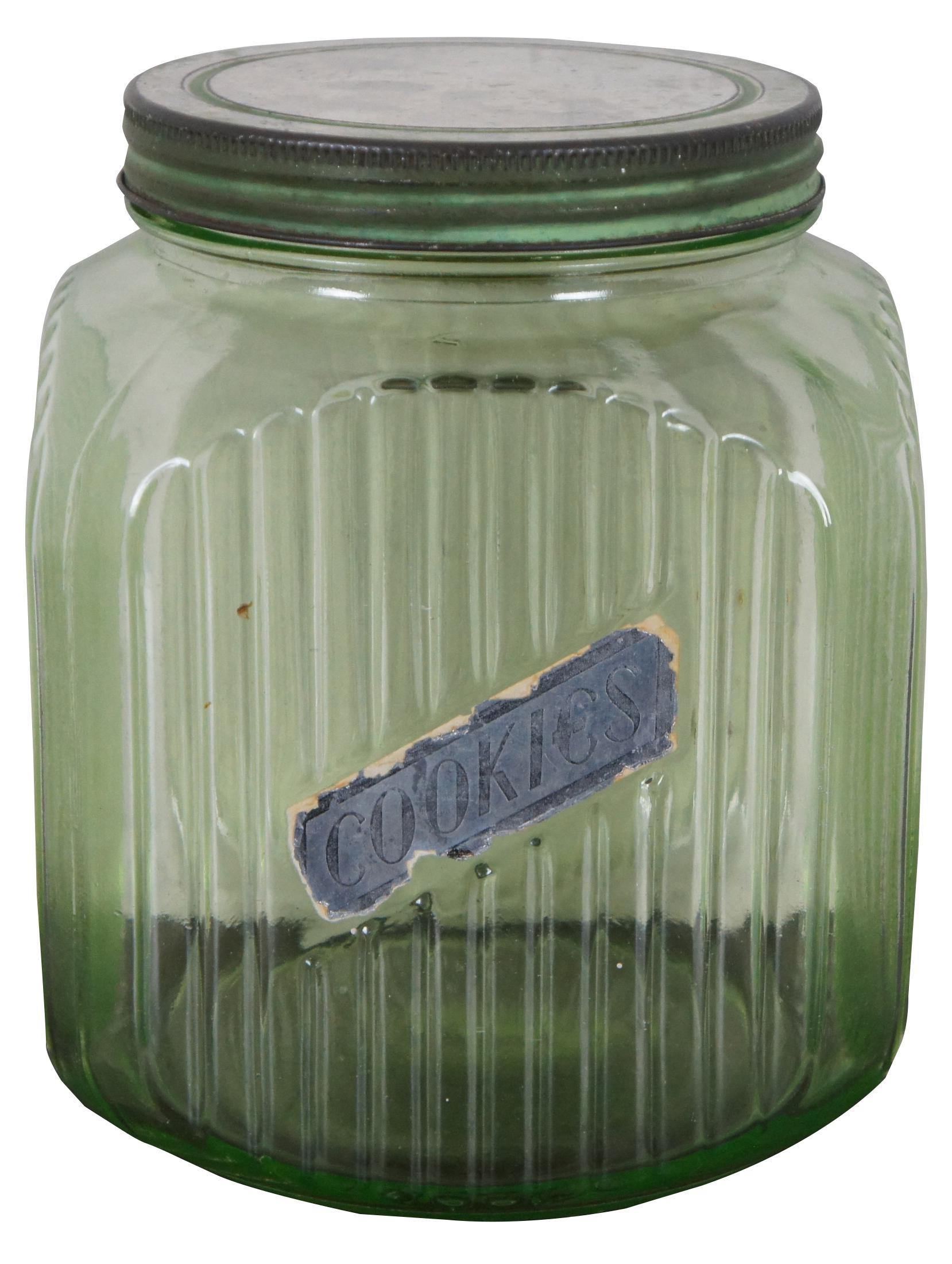 Antique light green uranium glass ribbed canister with metal screw top lid and Cookies label. Glows in UV light. 
 