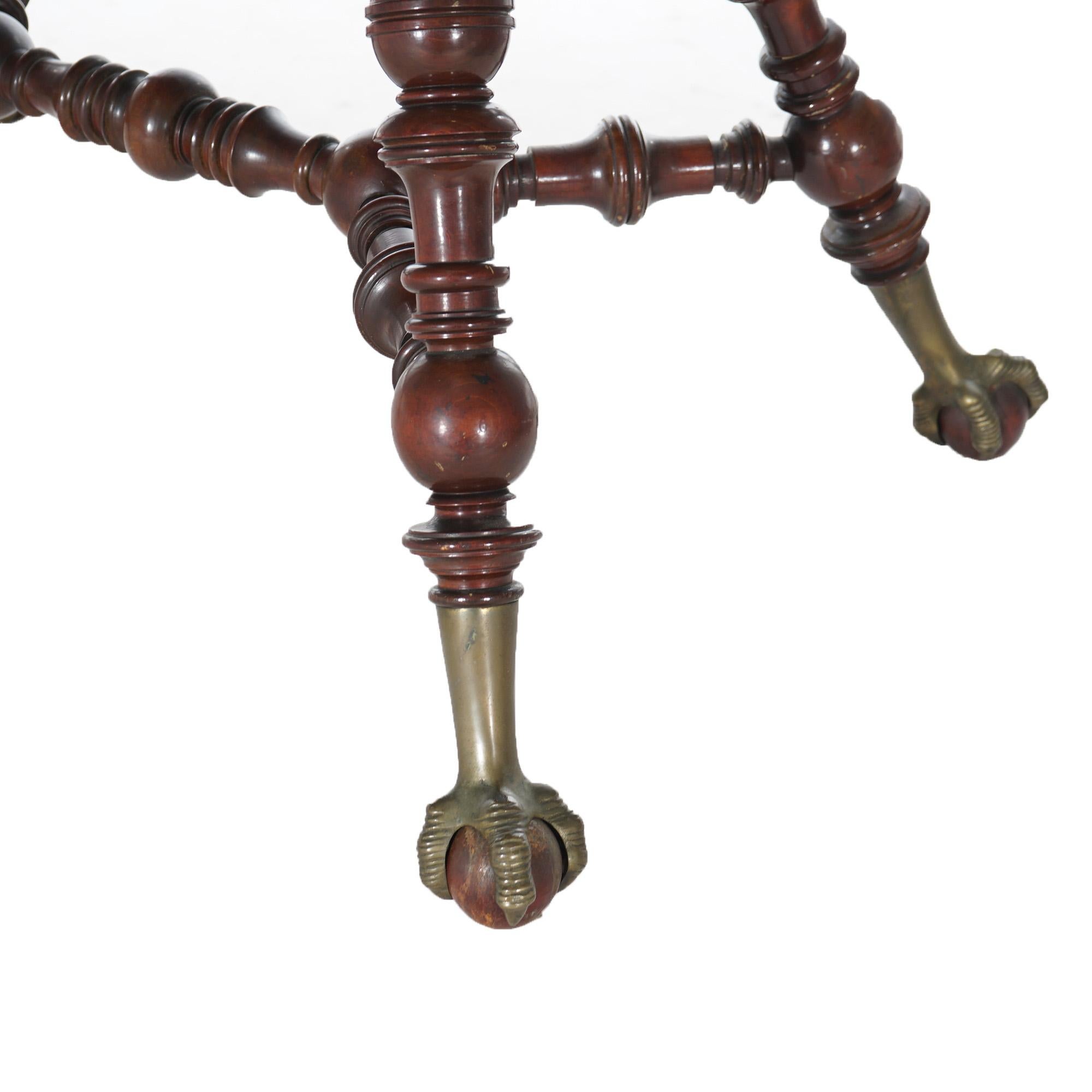 An antique parlor table in the manner of Horner or Hunzinger offers mahogany construction with balustrade legs, lower display and raised on claw and ball feet, c1890

Measures - 30.5