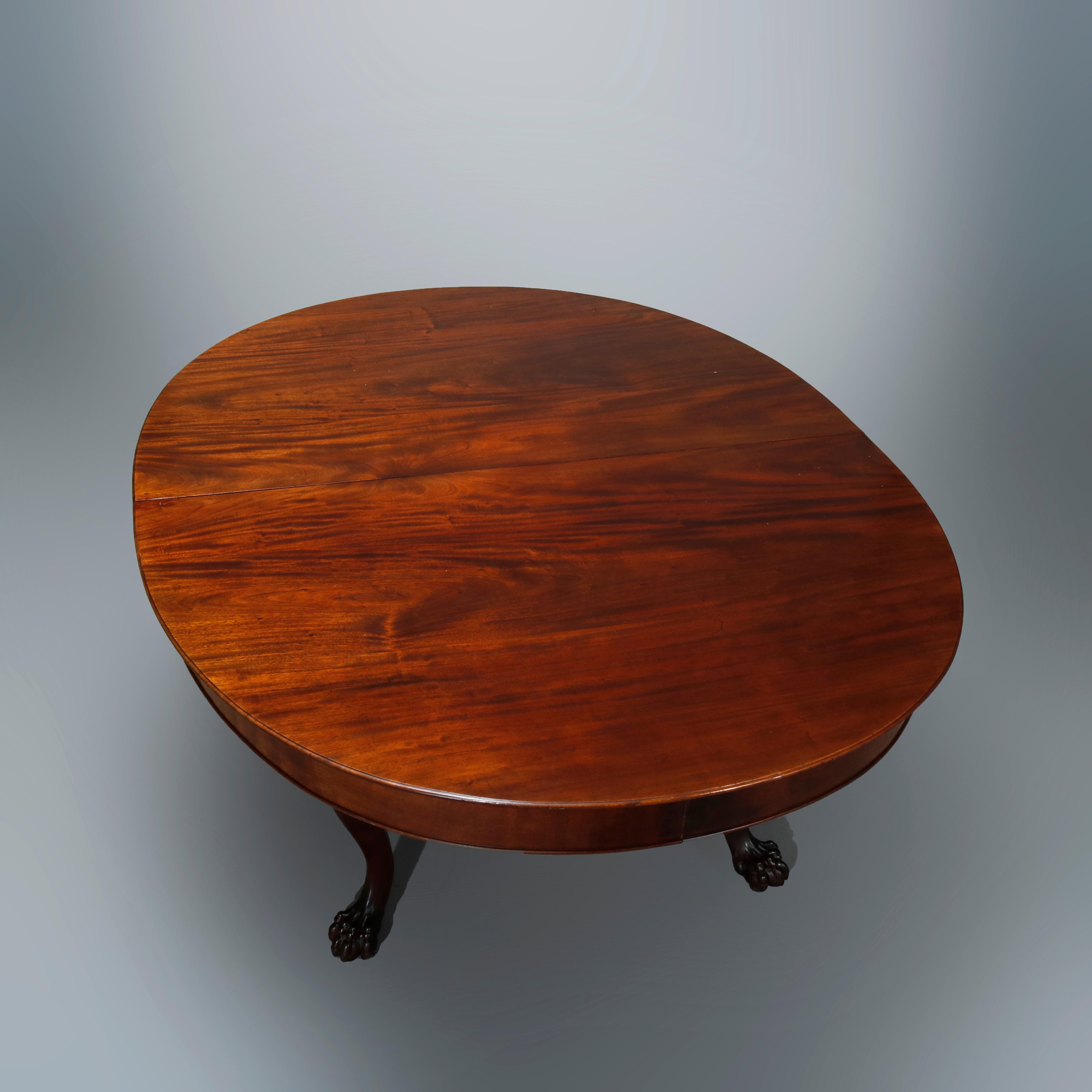 An antique extension banquet dining table in the manner of RJ Horner offers mahogany construction with deep skirt and raised on carved cabriole legs with carved knees and terminating in claw feet, includes eight leaves, letter of provenance as