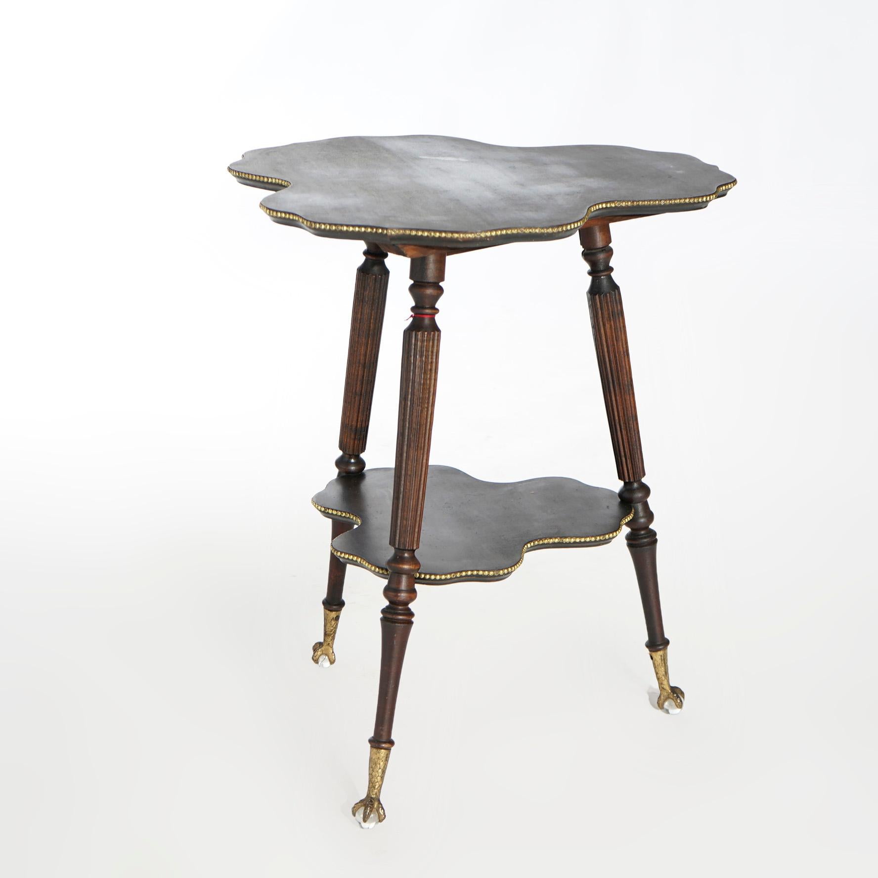An antique side stand in the manner of Horner offers mahogany construction with cloverleaf to and lower display raised on flared turned legs terminating in claw and ball feet, c1900

Measures- 30'' H x 25'' W x 25'' D.

Catalogue Note: Ask about
