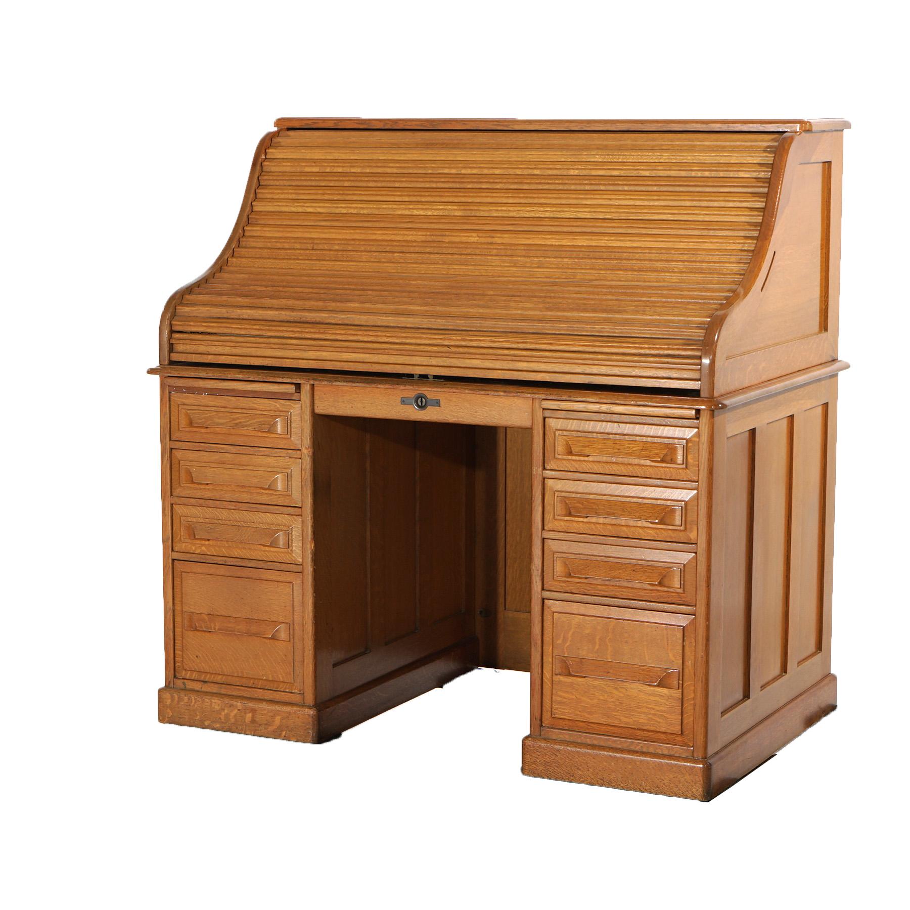 ***Ask About Lower In-House Shipping Rates - Reliable Service & Fully Insured***
An antique desk in the manner of Horner offers paneled oak construction with s-roll top opening to interior with storage compartments over lower case having central